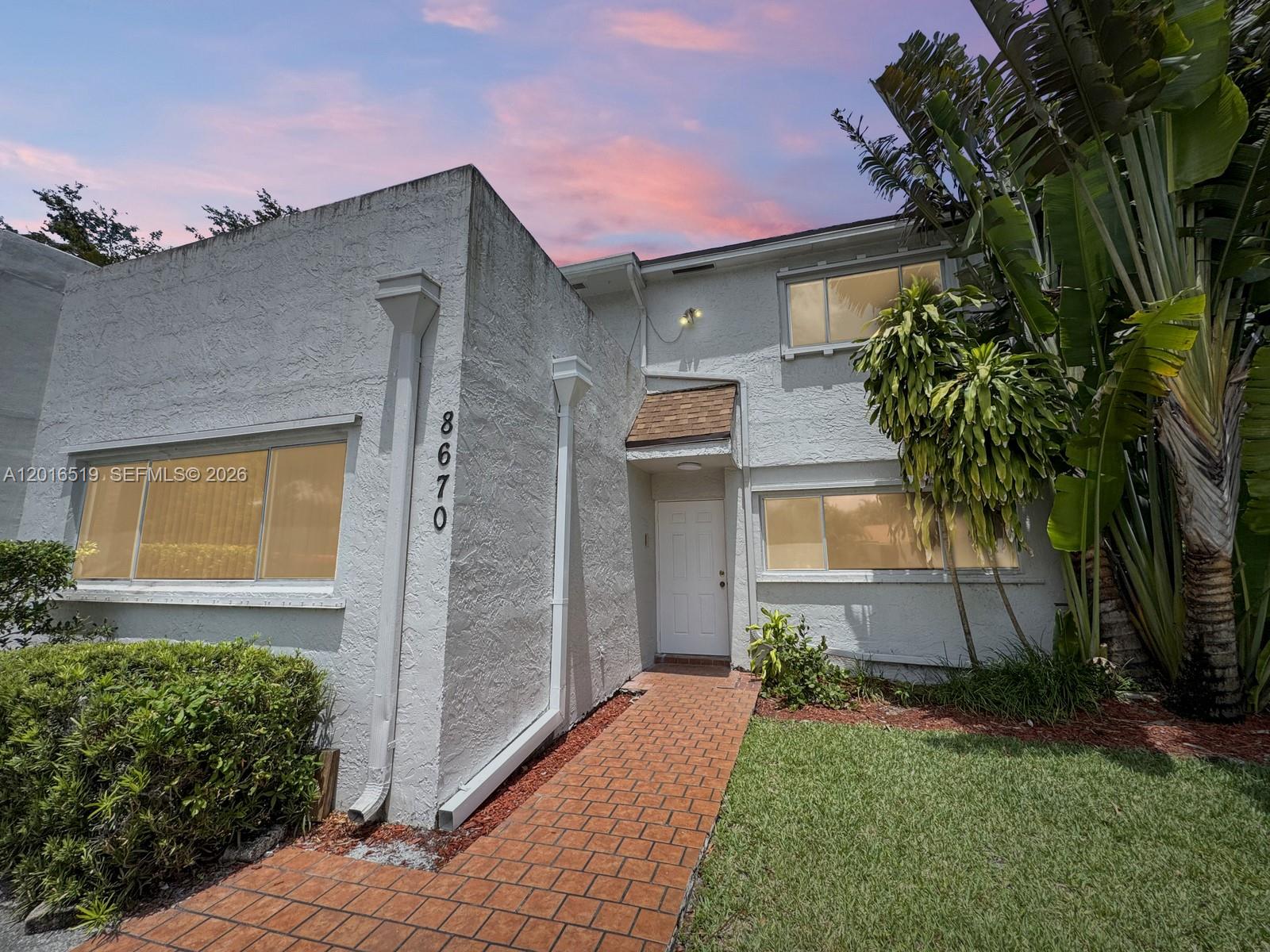 This multi level condo is located in the Alpine Woods Estates community in Davie and has 3 bedrooms 2 full bathrooms, and a 1/2 bathroom, plus an additional room that can be used as a bedroom, office, playroom, gym, the possibilities are endless. With 2,555 Square feet of living space this home has been well maintained and partially updated, with plenty of space and storage throughout. The layout includes a flex room on the entry level, the primary suite located a few steps above and two additional bedrooms with one bathroom on the second floor, with one of the bedrooms featuring a large private balcony. The kitchen offers pantry storage and space for a breakfast area table. The spacious primary suite includes a walk in closet and an updated en-suite bathroom with dual sinks and shower. The property also offers tranquil lake views from the backyard area and added privacy with no adjoining unit on one side. Pet friendly community allow for 2 pets per home. New roof already installed. Residents enjoy access to a community pool and tennis courts, along with convenient guest parking nearby. The property is located close to parks, shopping and dining. No lease first year of ownership.
