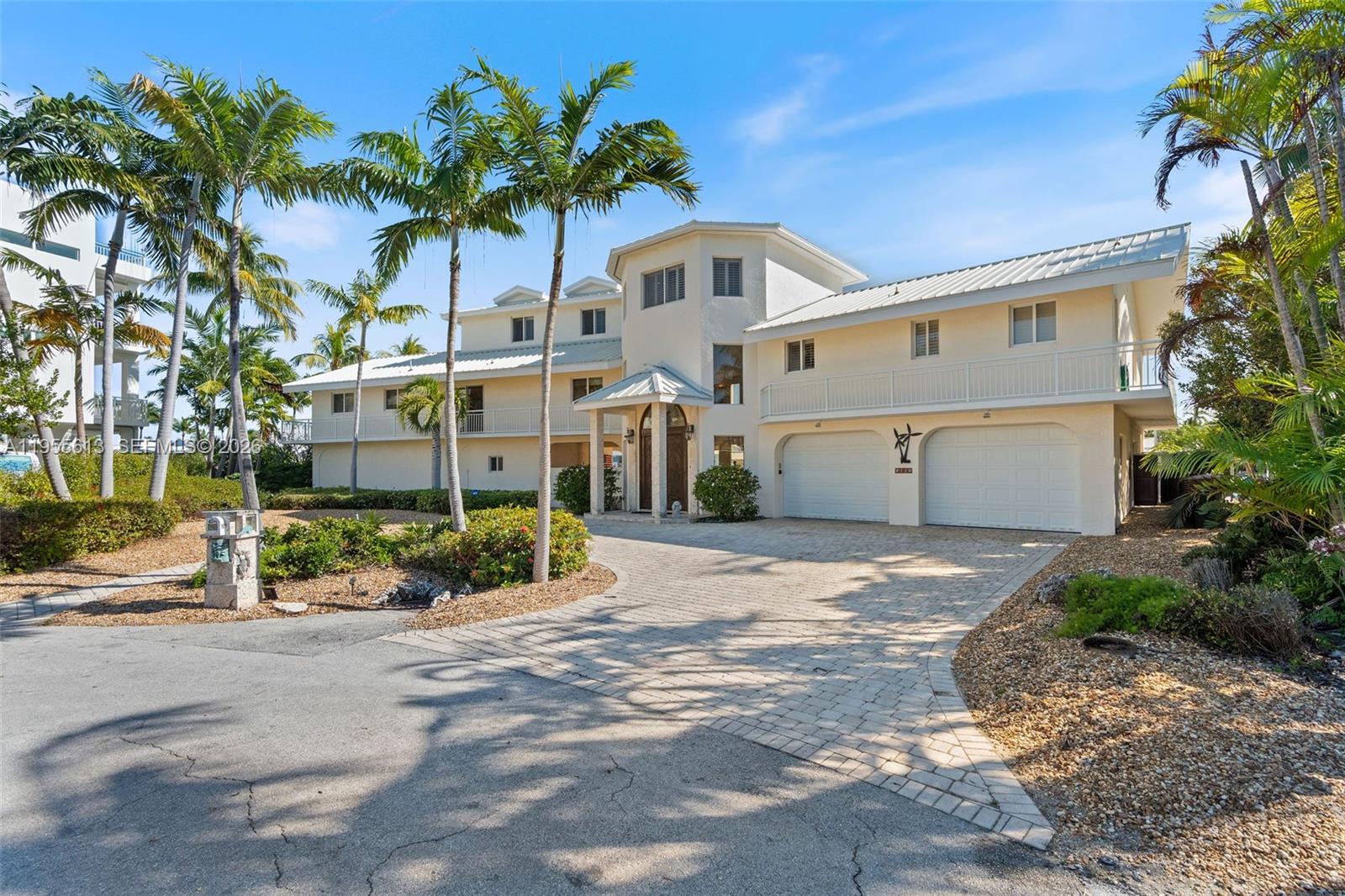Unparalleled Waterfront Command in Port Antigua. Boasting one of the largest water frontages in Islamorada's exclusive Port Antigua, this striking 3 story residence offers 4 bedrooms, 4.5 baths, and an extraordinary 220 feet of dockage with dual boat lifts. Every bedroom is beautifully appointed across thoughtfully designed living levels. Step outside to your private marina, where turnkey boating infrastructure meets the crystalline waters of the Florida Keys. Port Antigua residents enjoy exclusive access to a private beach and boat ramp amenities known only to a select few. Where unmatched dockage and island luxury converge in one of Islamorada's most coveted addresses.