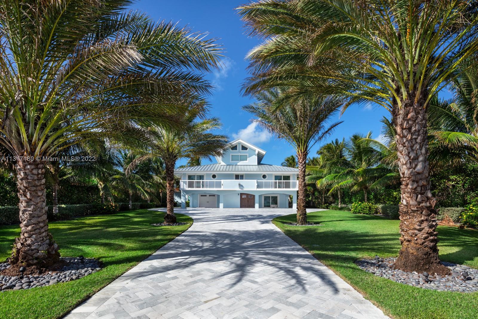 This trophy property features countless notes of specific attention to detail. A Home. A comfortable 5 bedroom; 4.5 bathroom that was designed to enjoy its peace and comfort with family or beautifully entertain guests. This Waterfront estate features breathtaking bay or ocean views from each room. Every inch of this property was recently remodeled, including Kitchen and bathroom faucets by Waterworks. This home's Kitchen is fully equipped with Sub-Zero and Wolf appliances. When the sun sets, enjoy your fire features which include a fire pit, tiki torches, and fire columns. The exterior features a New roof, Driveway, Pool, Dock with Boat/jet ski Lifts, Seawall, Covered BBQ, storage room, and a spacious guest structure. The location and design, make this home the perfect Florida Keys Estate.