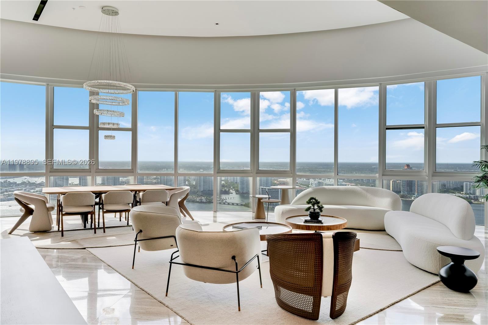 Perched on the 55th floor of the prestigious Trump Royale, this extraordinary two-story penthouse is a true sky mansion offering breathtaking panoramic views of the Atlantic Ocean, Intracoastal Waterway and Miami skyline.Spanning 5,727 SF of interior space,double-height living room with soaring 22-foot ceilings and floor-to-ceiling glass flooding the interiors with natural light while framing spectacular water and city views. A private in-residence elevator connects.The upper level hosts the main living areas including living, dining and gourmet kitchen designed for elegant living and entertaining.The residence is offered fully furnished with a curated collection of brand-new ultra-luxury designer, purchased exclusively to stage the property and never used, creating a sophisticated turnkey environment.The gourmet Poliform kitchen features marble countertops, Hansgrohe fixtures and premium Wolf and Sub-Zero appliances. Additional highlights include marble and wood flooring, custom finishes and a temperature-controlled wine cellar with capacity for up to 500 bottles.Outdoor living reaches new heights with an expansive private terrace featuring a pool and jacuzzi overlooking the Atlantic Ocean and Miami skyline.Residents enjoy amenities including private beach service, lagoon-style pool, spa, fitness center, tennis courts, concierge, valet and 24-hour security.A rare trophy penthouse offering exceptional scale, privacy and breathtaking views in the heart of Sunny Isles Beach.