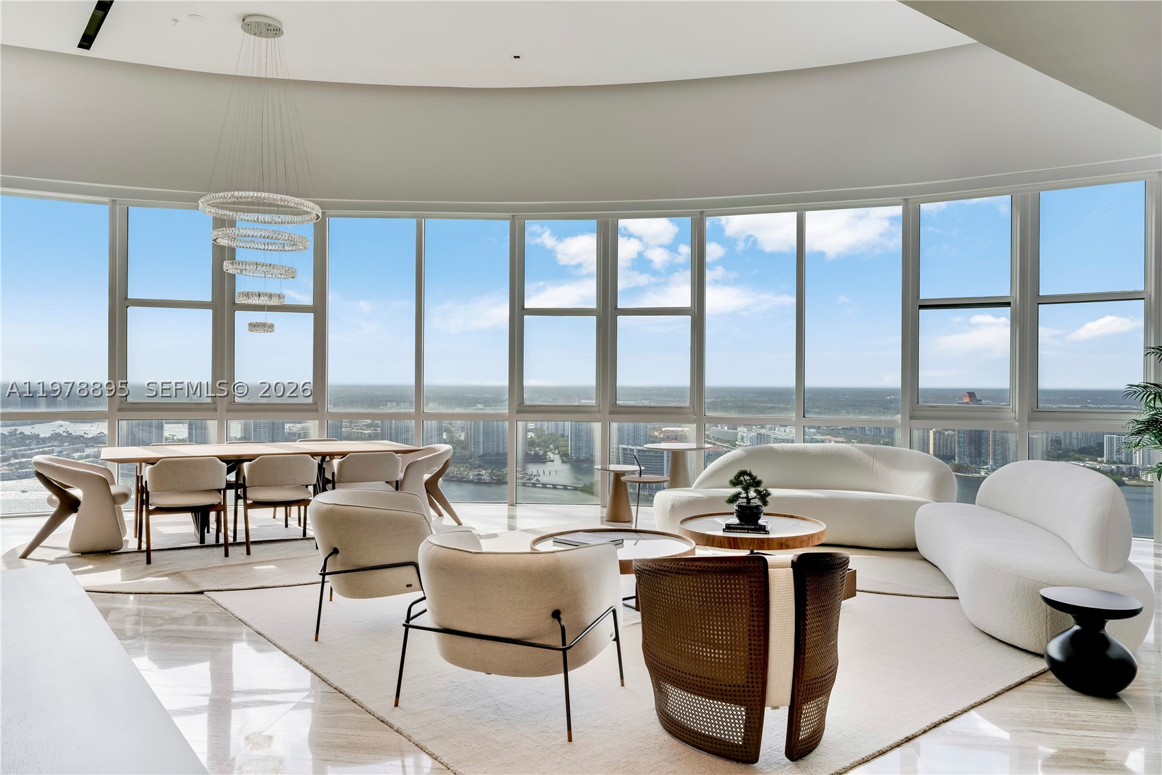 Perched on the 55th floor of the prestigious Trump Royale, this extraordinary two-story penthouse is a true sky mansion offering breathtaking panoramic views of the Atlantic Ocean, Intracoastal Waterway and Miami skyline.Spanning 5,727 SF of interior space,double-height living room with soaring 22-foot ceilings and floor-to-ceiling glass flooding the interiors with natural light while framing spectacular water and city views. A private in-residence elevator connects.The upper level hosts the main living areas including living, dining and gourmet kitchen designed for elegant living and entertaining.The residence is offered fully furnished with a curated collection of brand-new ultra-luxury designer, purchased exclusively to stage the property and never used, creating a sophisticated turnkey environment.The gourmet Poliform kitchen features marble countertops, Hansgrohe fixtures and premium Wolf and Sub-Zero appliances. Additional highlights include marble and wood flooring, custom finishes and a temperature-controlled wine cellar with capacity for up to 500 bottles.Outdoor living reaches new heights with an expansive private terrace featuring a pool and jacuzzi overlooking the Atlantic Ocean and Miami skyline.Residents enjoy amenities including private beach service, lagoon-style pool, spa, fitness center, tennis courts, concierge, valet and 24-hour security.A rare trophy penthouse offering exceptional scale, privacy and breathtaking views in the heart of Sunny Isles Beach.
