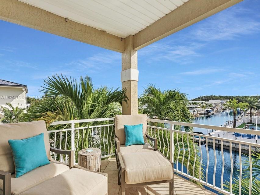 Discover paradise in Key Largo! This 3-bed, 2-bath home, built in 2009, epitomizes coastal luxury. With a durable metal roof and a concrete dock boasting a 15,000-pound boat lift, it's a boater's haven. Enjoy gorgeous canal views, with quick bay access and easy ocean access via Adam's Cut. Fully furnished and turnkey, the beautifully decorated interior features many upgrades. Two balconies offer relaxation and entertainment: one with canal views and the other with glimpses of the bay. Centrally located and close to Miami, this residence is a waterfront retreat. Additional features include an outdoor shower, a downstairs storage area serving as a convenient guest suite and a finished attic with a bunk room. Your Key Largo dream home awaits!