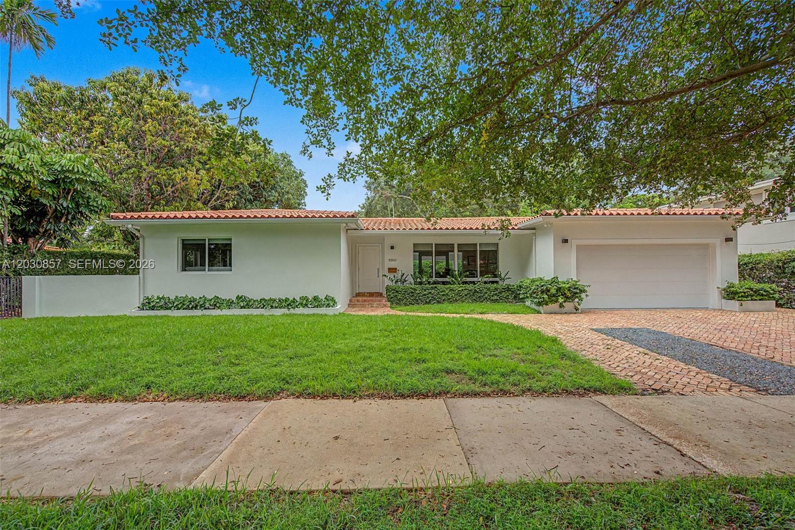 Lovingly maintained 3BR/2BA in prime South Gables on an oversized 10,000 SF lot facing a beautiful green space. Quiet street, multi-million-dollar homes across the way, and natural light everywhere you look. The kitchen features SieMatic German cabinetry, a Sub-Zero refrigerator, and Miele appliances. Marble and hardwood floors throughout, PGT impact windows and doors, PVC plumbing, and recent A/C. Out back you'll find a private pool with a coral-stone deck that stays cool underfoot, plenty of yard for an addition, a 67-ft rear covered patio, and a shaded side patio in old Chicago brick. Climate-controlled two-car garage. Minutes from US-1 and Granada, close to everything. Move-in ready. A very special home.