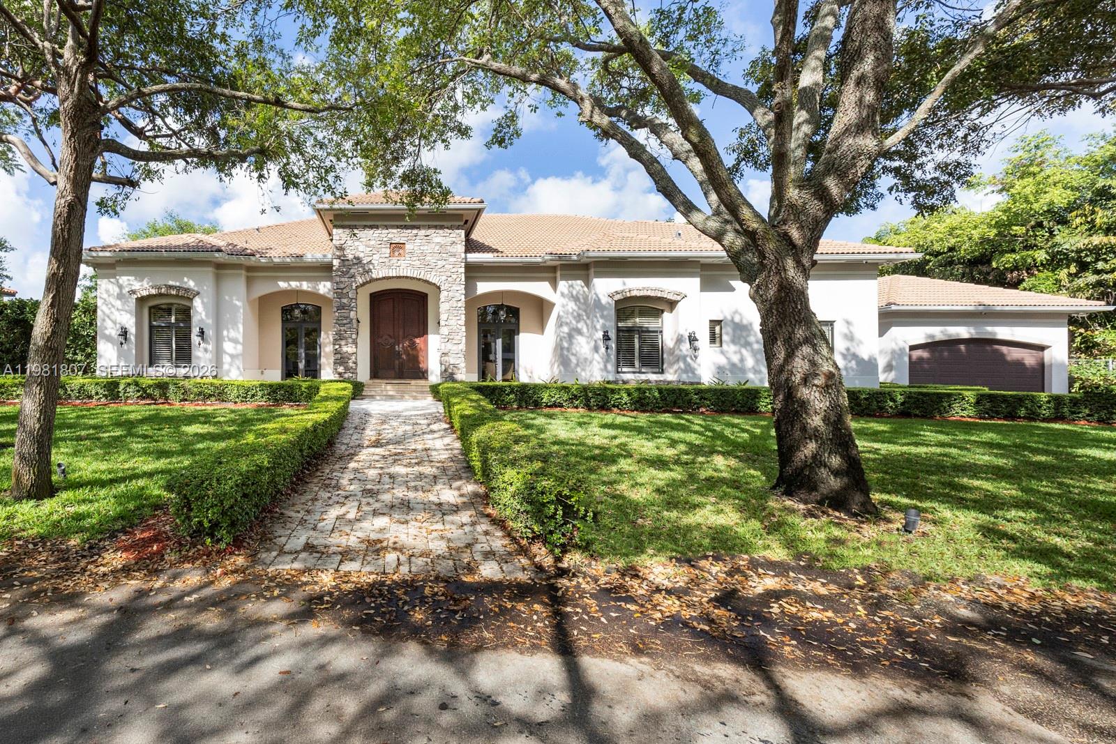 Custom-built 2007 estate in the highly sought-after Glenvar Heights neighborhood, offering exceptional craftsmanship and designed for both comfortable living and entertaining. This residence features 4 bedrooms, 4 full bathrooms, a private office, formal living and dining rooms, a wet bar, and wine closet. The chef’s kitchen includes stainless steel appliances, a chef’s pantry, eat-in dining area, and an oversized island that opens seamlessly to a spacious family room.

Interior highlights include impressive volume ceilings, elegant stone flooring throughout the main living areas, and hardwood floors in the bedrooms. A striking solid custom front door creates a grand entrance, while impact windows with rolling shades and blackout treatments in the bedroom areas provide comfort and privacy.

Recent upgrades include a Savant Smart Home System, new lighting package, camera security system, full-home generator, and sound system throughout the home and outdoor areas.

The backyard is designed for entertaining with a pool, covered terrace, and gazebo featuring a built-in Viking grill, bar, and sink. Fully fenced yard.

2-car garage with vehicle lift. Ideally located near excellent schools, shopping, and major roadways.