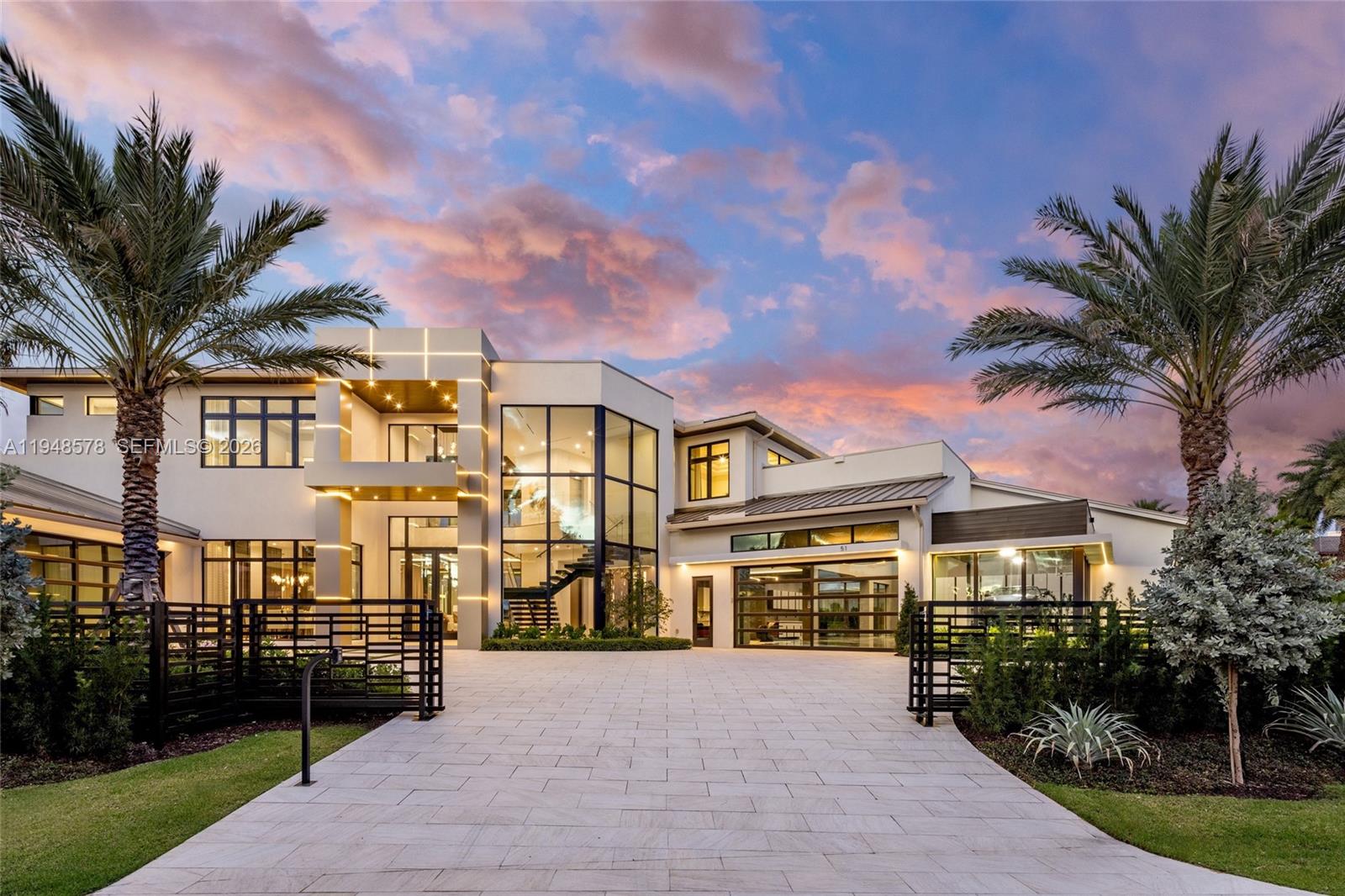 A truly one-of-a-kind waterfront estate, designed without compromise for the serious collector, entertainer, and yachtsman. Located within the prestigious Harbor Beach community, this architectural statement spans nearly 13,000 square feet & delivers 6 bedrooms, 6 full & 2 half bathrooms. At its core is an extraordinary 3,000+ square foot, air-conditioned showroom garage engineered for vehicle lifts to accommodate 17+ cars, complemented by a separate 20’ x 20’ two car garage. Interiors impress with 48” porcelain flooring throughout, a dramatic floating staircase, custom ceiling details, 12-ft second-floor ceilings, and walls of glass framing serene water views. The chef’s kitchen features Italian Cesar cabinetry, Taj Mahal stone countertops, Wolf and Sub Zero appliances, a butler’s kitchen with integrated coffee system, and three dishwashers. Additional highlights include dual laundry rooms, elevator, gas systems, & fully built out closets. The first floor club room offers a private lounge experience with a pub-style full bar, wine coolers, & kegerator, complemented by dedicated media, gym, & theater rooms. Outdoor living rivals a private resort with a heated saltwater infinity pool, summer kitchen, primary suite terrace with outdoor bar, stained oak ceilings, & a new concrete dock & seawall with pedestals & generator providing immediate ocean access just minutes from the beach and Fort Lauderdale International Airport.