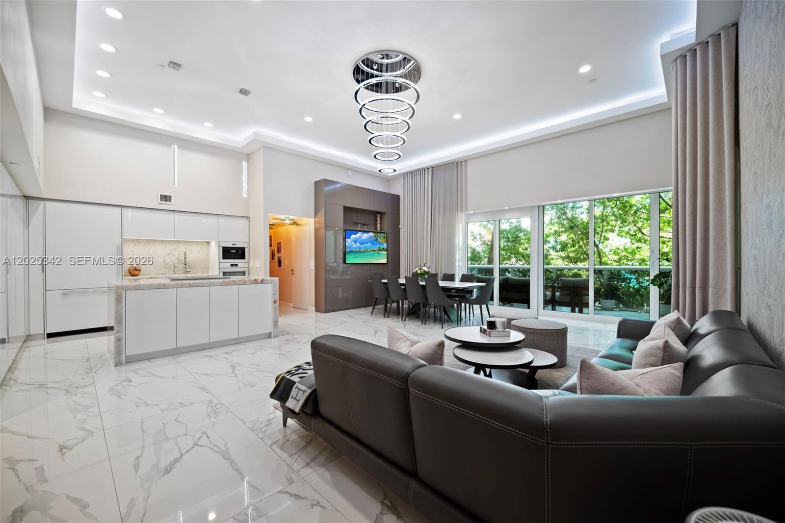Experience elevated oceanfront living in this fully reimagined designer residence at the prestigious Beach Club in Hallandale Beach. This stunning home blends modern sophistication with resort-style luxury, featuring soaring double-height ceilings, oversized porcelain flooring, custom lighting, and expansive living spaces filled with natural light. The sleek chef’s kitchen is a true centerpiece with custom cabinetry, premium integrated appliances, and a dramatic waterfall island designed for both entertaining and everyday living. Floor-to-ceiling glass doors open to a private terrace surrounded by lush tropical landscaping, creating the perfect indoor-outdoor South Florida lifestyle.
The residence also features a spectacular custom-built walk-in closet, spa-inspired finishes, and impeccable attention to detail throughout. Located in one of South Florida’s premier oceanfront resorts, residents enjoy access to world-class amenities including a full-service luxury spa, oceanfront fitness center with state-of-the-art equipment, resort-style pools, private beach service, valet, concierge, café, 24-hour security, and five-star hotel-style services.
Perfectly positioned between Miami and Fort Lauderdale, the Beach Club offers unparalleled convenience just minutes from Aventura Mall, Bal Harbour Shops, Gulfstream Park, fine dining, luxury shopping, and private aviation. A rare opportunity to own a turnkey residence in one of South Florida’s most sought-after beachfront communities.