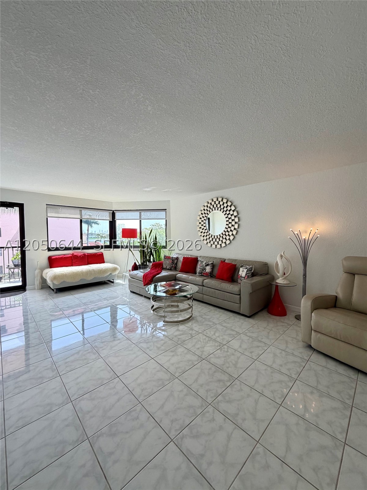Beautifully maintained apartment in mint condition. Renovated kitchen, doors, floors, and bathrooms! Washer and Dryer inside the unit. Large balcony with a lot of light and partial views of the lake.  Electronic gate and lobby entrance. Facing the side of the lake with walking paths, a spacious pool, and a jacuzzi. One assigned parking space and plenty of guest parking for your guests.