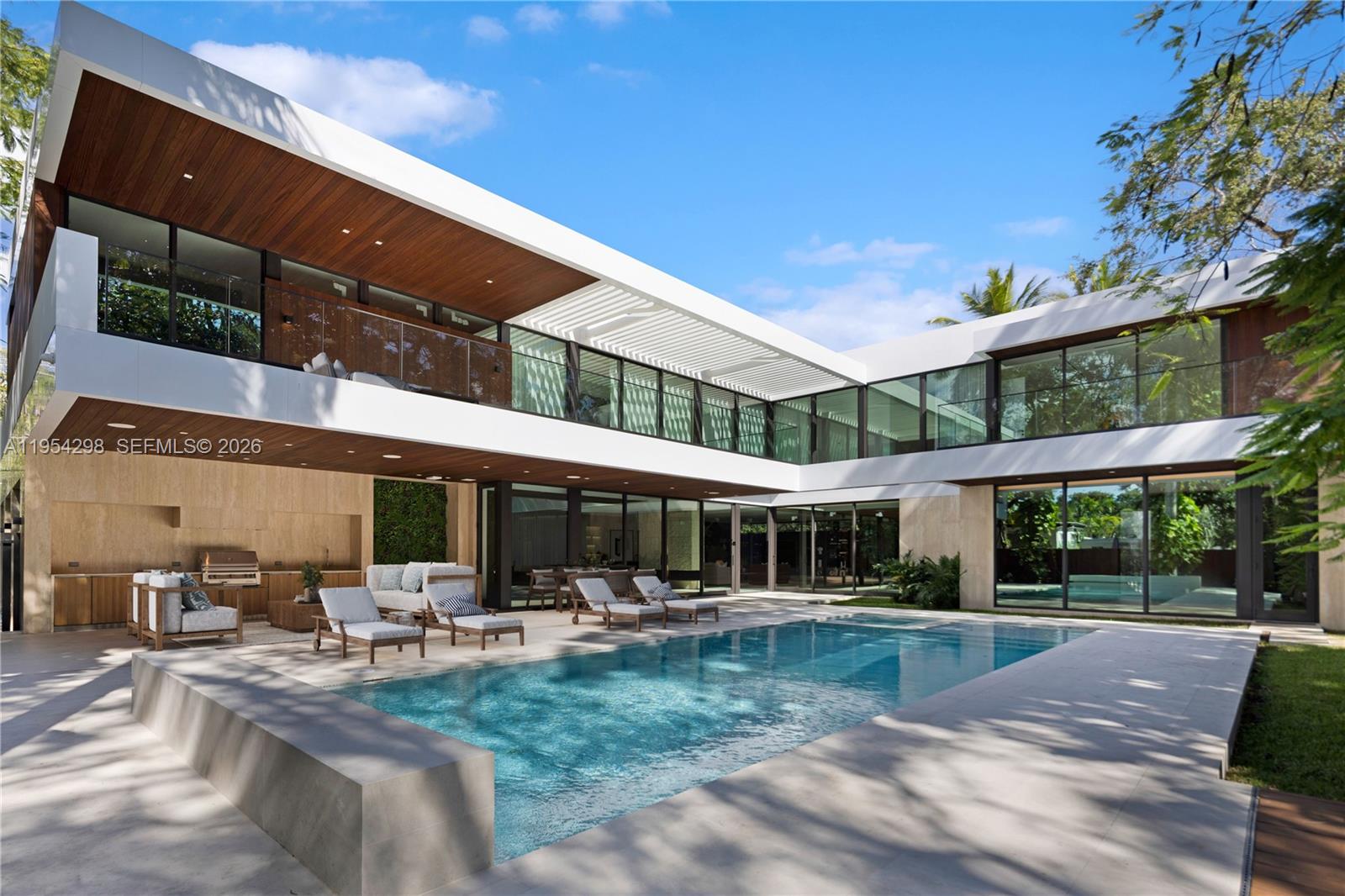 Live the ultimate North Grove lifestyle in this newly completed architectural estate on a 16,741-sq-ft corner lot with over 10,000 sq ft of refined modern design. Enter through dual gated streets into a residence curated for grand entertaining and everyday luxury. The home offers 6 bedrooms and 7.5 baths including staff quarters, all with en-suite baths, walk-in closets and private terraces. Highlights include a dramatic great room with water vapor fireplace, chef’s kitchen with Gaggenau appliances, prep kitchen featuring Thermador appliances, theater, gym and office. Outdoor spaces feature a kitchen, cabana bath, shower, steam shower, pool, spa, and terraces. Crestron smart home technology and a 16-camera security system ensure privacy and peace of mind.
