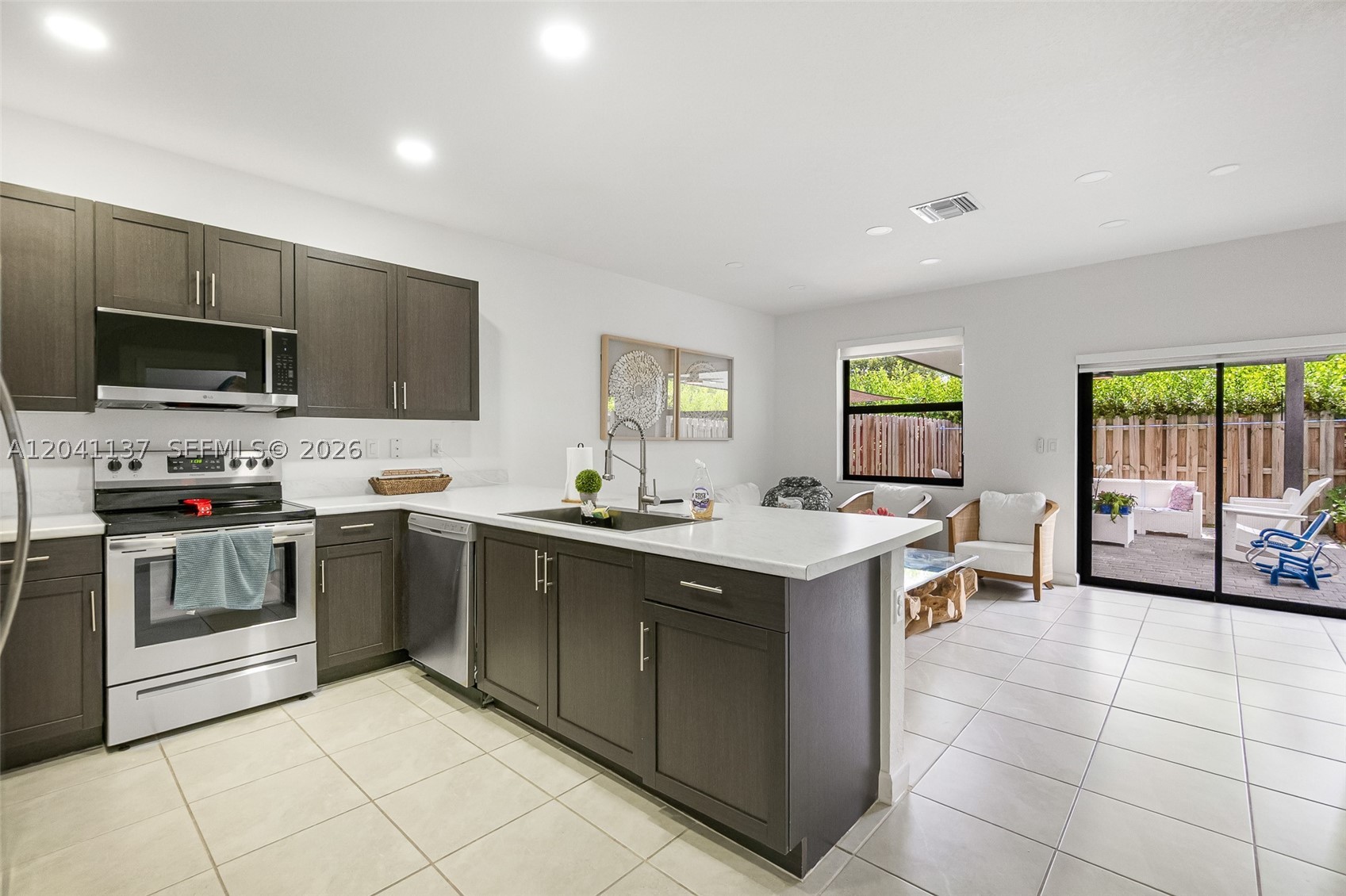Welcome to this beautifully upgraded townhouse located in the highly desirable Pine Isle community. This move-in-ready home offers the perfect blend of comfort, style, and security in a peaceful, family-oriented neighborhood.

Enjoy peace of mind with impact-resistant windows and numerous upgrades throughout the home. The second floor features upgraded flooring, while the bathrooms have been enhanced with modern shower fixtures and finishes. The kitchen boasts upgraded fixtures, including a stylish sink and faucet, creating a fresh and contemporary feel.

Step outside to your private outdoor space featuring a custom pergola, perfect for entertaining, relaxing, or enjoying Florida's beautiful weather year-round.

Residents of Pine Isle enjoy access to exceptional community amenities, including a clubhouse, resort-style swimming pool, and well-maintained common areas. The gated and secure community provides a welcoming environment with excellent security and a strong sense of neighborhood pride.

Conveniently located near shopping, dining, schools, and major highways, this home offers the ideal combination of modern upgrades, community amenities, and everyday convenience.

Don't miss this opportunity to own a beautifully upgraded home in one of the area's most sought-after communities.
