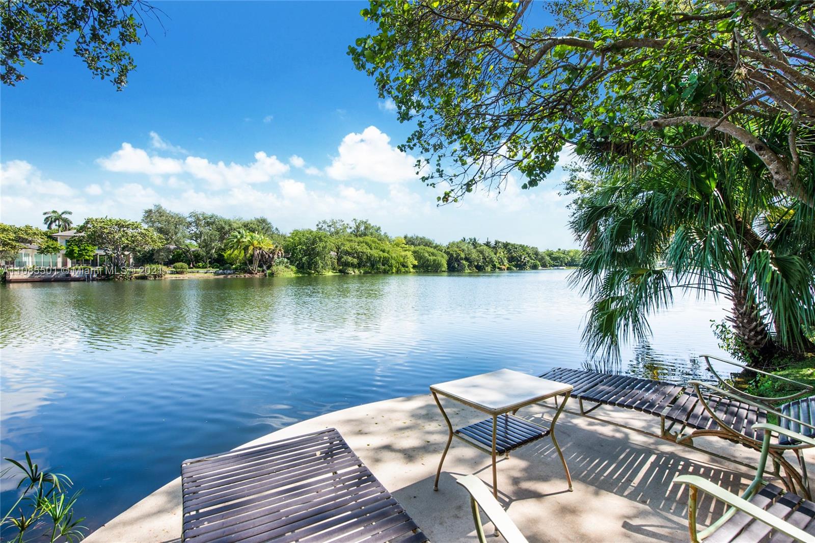 Unbelievable opportunity can be yours! Original owners parting with this spectacular custom modern sprawling estate on magnificently landscaped private lakefront 1.4 acre property. Highly desirable exclusive gated neighborhood of Hammock Lake II over 6,000 square foot gem. Very large 4 ensuite bedrooms in main, large chef's kitchen, wet bar, guest bath, stately built-in office, 2 car garage, 4 car carport, additional separate quarters with bath. Enjoy walking paths through professionally designed lushly landscaped lot. Stroll through the oaks and fan tail palms to your private dock to watch the sunset on the lake. Original owners selected single sourced Mahogany which grace this home's uniqueness and sophistication. Private showings only scheduled with listing agent.