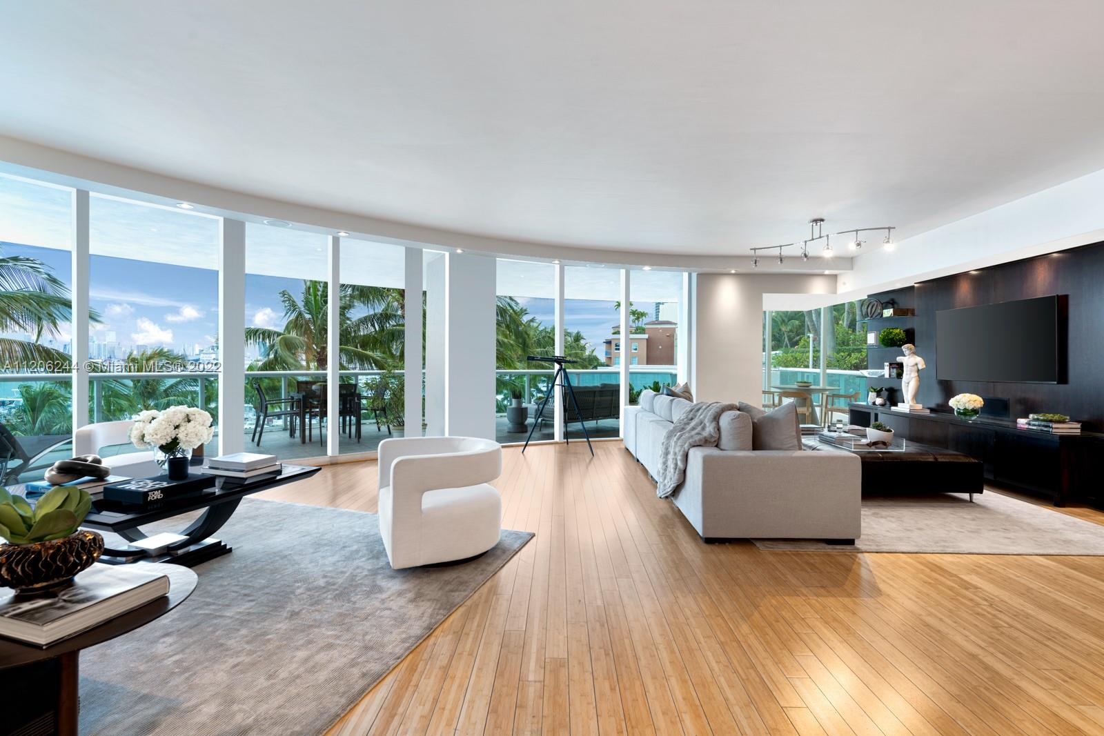 Step Inside With Me!  A South of Fifth legendary floorplan - Murano’s 01 line- offering the best of both worlds: the services of a premier waterfront condominium with the expansive outdoor space unique to a single-family residence.  Floor-to-ceiling windows encase this spectacular curved floor plan with lovely Western views of the bay, marina and downtown skyline. With 3 bedrooms + office, outdoor living is made prominent with both a sprawling wraparound terrace paired with a one-of-a-kind lanai featuring putting green and private access to one of the building’s swimming pools and tennis court. Murano at Portofino offers a chic private restaurant and Beach Club for its residents, as well as all the top amenities of SoFi - the park, marina, and dozens of restaurants at your footstep
