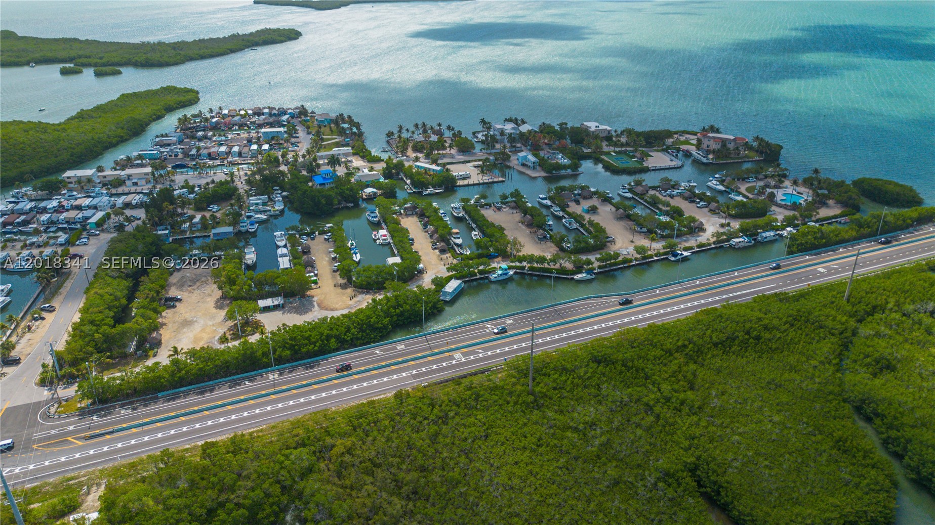 Price Repositioned! Rare opportunity to own a 38' dock slip in the private gated marina at Manatee Bay Club, ideally located near the Miami-Dade and Monroe County line. Enjoy the convenience of being less than an hour from downtown Miami while still having direct access to the Florida Keys boating lifestyle. This protected marina offers convenient access to both the Intracoastal Waterway and the Atlantic Ocean and is recognized locally as a desirable hurricane-safe harbor. Slip C13 can accommodate vessels up to approximately 36' overall length, allowing for recommended clearance at each end. Features include approximately 4'-5' draft at the slip, aluminum dock construction, water hookup, and metered electric service. 25ft. Deeded upland area, Private tiki hut, Dock box/storage, Two dedicated parking spaces

The marina's brackish water environment is easier on vessels and helps minimize bottom growth.

Community amenities include Sandy beach area, Boat ramp, Swimming pool, Hot tub, Showers and restrooms, laundry facilities, Ice machine, On-site marina staff and maintained grounds

Ownership includes access to marina facilities, grounds maintenance, water, and sewage service. LIVEABOARD use is permitted. * Submerged vessel currently onsite; vessel to be removed prior to or upon closing. Photos depict potential boat slip condition and may not reflect the current presence of the submerged vessel.