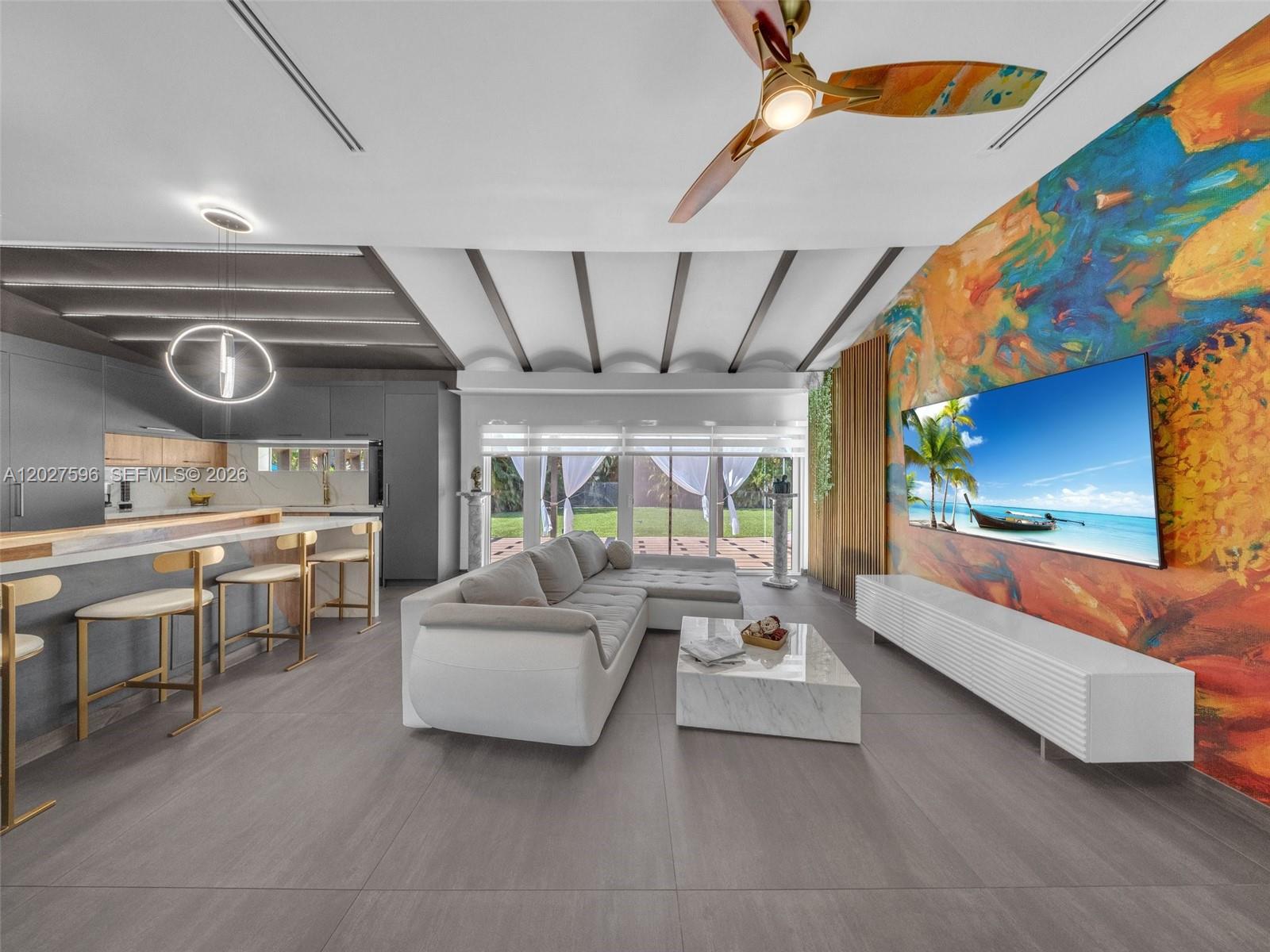 This extraordinary D’Lola-designed residence blends European sophistication with modern luxury. Situated on an oversized double lot with room for a pool, this custom 4-bed, 4-bath estate showcases an impressive foyer featuring a dramatic full-wall waterfall feature and eclectic vaulted ceilings that create an unforgettable first impression. Thoughtfully designed split floor plan offers privacy and functionality, including a private west wing bedroom and bath. Stunning open-concept chef’s kitchen is a true showpiece, featuring imported dark grey Graffito cabinetry from Spain, a blend of butcher block and quartz countertops w/ waterfall edge, SS Samsung appliances, and gas cooktop. Luxury flows throughout with oversized 42x42 imported Italian ceramic tile, custom modern lighting, sleek glass enclosures, designer doors, linear A/C vents, and smart Alexa-integrated switches. Major upgrades include impact windows and doors throughout, new plumbing, updated electrical, new A/C ducts, new baseboards, lighting, and custom finishes. The spacious primary suite is a private retreat with direct backyard access, double closets, and a spa-inspired cabana bath featuring a soaking tub, separate shower, and stunning custom Italian tilework. Step outside to your backyard oasis with a partially covered patio and pergola. This one-of-a-kind residence is the perfect fusion of European design, luxury finishes, and timeless architecture—crafted for buyers seeking something truly exceptional.