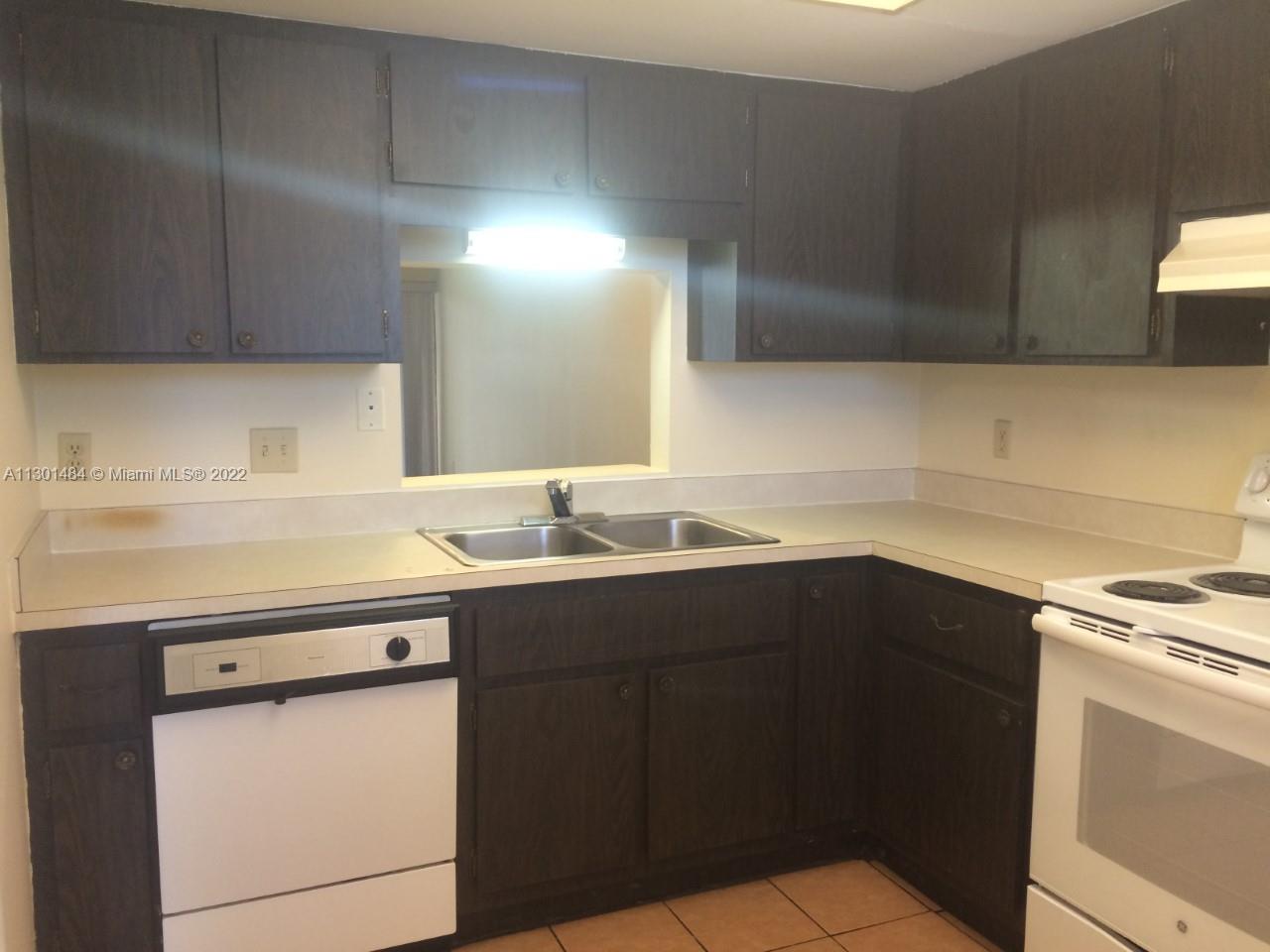 Well-maintained and move in ready starter home or investment property.  This is legally a 1 bedroom/ 1-1/2 bath unit but could easily be made into a 2 bedroom by adding a wall. This unit has vinyl/laminate flooring throughout.  It is a corner property with views of the lake that you can enjoy from your enclosed and covered balcony. Maintenance includes upkeep of the common areas, laundry facilities (which are conveniently located directly outside of this unit), insurance, water & sewer, pool, clubhouse, library, and exercise room. This unit, although located on the second floor, has a ramp that leads directly from your parking space to the unit.  This propety is located minutes from A1A, pristine beaches, historic downtown Ft. Pierce, Florida's Turnpike and I-95.  Don't miss out!