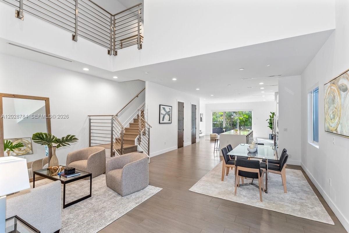 Enjoy modern urban living in this like-new contemporary home featuring high-end finishes and a bright open floor plan. A dramatic 20-ft ceiling welcomes you into the spacious living and dining areas, centered around a custom gourmet kitchen. All three bedrooms feature en-suite bathrooms, plus a convenient half bath for guests. Expansive glass walls open to a Zen-inspired patio and private sparkling pool, creating the perfect indoor-outdoor lifestyle.
