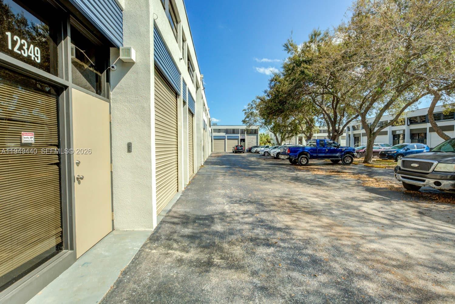 Gorgeous remodeled commercial LEGAL two-story warehouse and offices, with separate entrances for the first floor and the second floor, large ground level bay door, four private offices upstairs, open warehouse area downstairs, two bathrooms (one upstairs and one downstairs), two assigned parking spaces, guest parking spaces and handicap parking spaces.  Additional on-street parking available.  Low maintenance fees at $319 per month.  Separate entrances for first and second floor, possible additional rental income.  Association is in excellent financial position, great reserves, just passed the 40-year recertification. LEGAL 1,440 SQUARE FOOT UNIT, AS PER MIAMI-DADE PROPERTY APPRAISER.