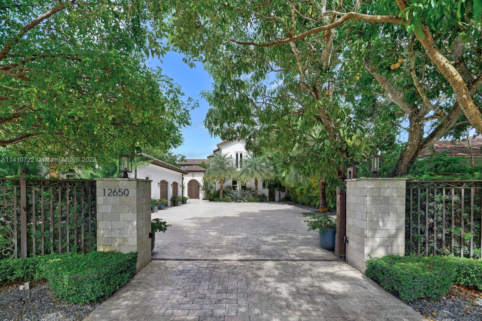 An elegant fusion of contemporary style and Spanish-Moroccan architecture offers an unparalleled, luxury, living experience. Features include home theater, chef’s and summer kitchen, wine gallery, picturesque courtyard, inviting breezeways, koi pond and spiral staircase to a lagoon-style pool. Generous lounging areas showcase its exceptional entertainment space. Remarkable primary suite leads to a breathtaking, serene private terrace. Detached guest house and maid’s quarters allow for added privacy. Come indulge in this thoughtfully designed modern retreat.