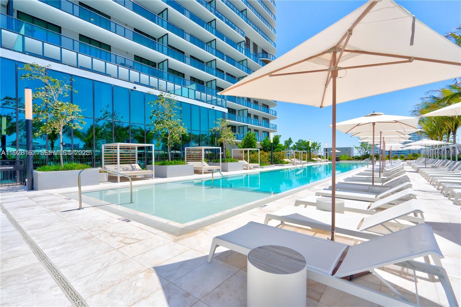 New-Construction ! 2 bedrooms residences with modern layouts and expansive private balcony. Perfectly situated blocks from the beach and approved for short-term rentals, the property features a grand double-height lobby, advanced smart-building technology, and resort-style amenities. Enjoy a 150-foot pool with cabanas, a fitness center, yoga lounge, kids’ playroom, and multiple dining venues. Residents benefit from a private rooftop with panoramic views, a golf cart shuttle to the beach, and lifestyle concierge services. This residence comes fully furnished with floor-to-ceiling glass doors, high ceilings, and breathtaking views of the ocean, park, and skyline.