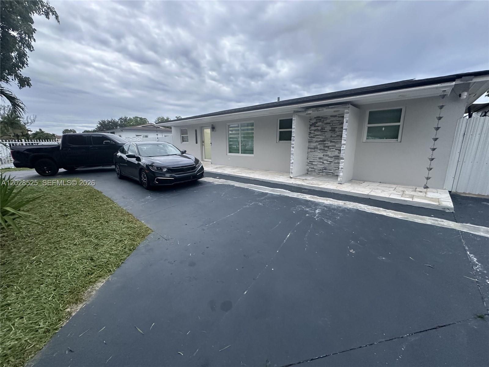 Fully renovated Miami Gardens home, move-in ready and designed for modern living. This turnkey property features impact windows and doors throughout, tile flooring, two fully remodeled bathrooms, and an open-concept kitchen with a large island and light granite countertops that bring natural light and extra functionality to the space. Enjoy an oversized fenced driveway with metal fencing, parking for 6+ vehicles, plus side access with room for a boat, jet skis, RV, or work trucks. The spacious primary bedroom includes a large walk-in closet. Excellent opportunity to own a renovated home in Miami Gardens with space, parking, upgrades, and convenience.