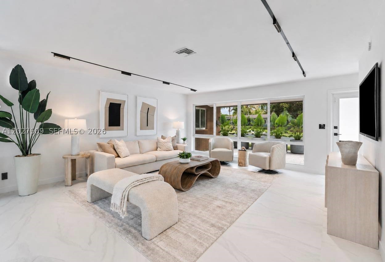 IDEAL FOR FAMILIES • EXCEPTIONAL AIRBNB POTENTIAL *** Completely reimagined with a fully permitted renovation, this move-in-ready home offers luxury, peace of mind, and exceptional value just 1.5 miles from the beach. Major upgrades include new electrical wiring and panel, brand-new HVAC, impact windows and doors, new water heater, and new pool equipment—providing long-term reliability, lower maintenance, and potential insurance savings. *** The open-concept layout features porcelain tile flooring, a designer kitchen with waterfall quartz countertops, custom soft-close cabinetry, and premium appliances. A private guest suite with its own entrance and full bath is ideal for multigenerational living, guests, a home office, or Airbnb potential. Enjoy a resort-style backyard with a sparkling upgraded pool, new marble pool deck, outdoor kitchen, and lush landscaping. Located on a quiet, non-through street with no HOA, just minutes from the beach, Lauderdale-by-the-Sea, shopping, dining, marinas, and golf.