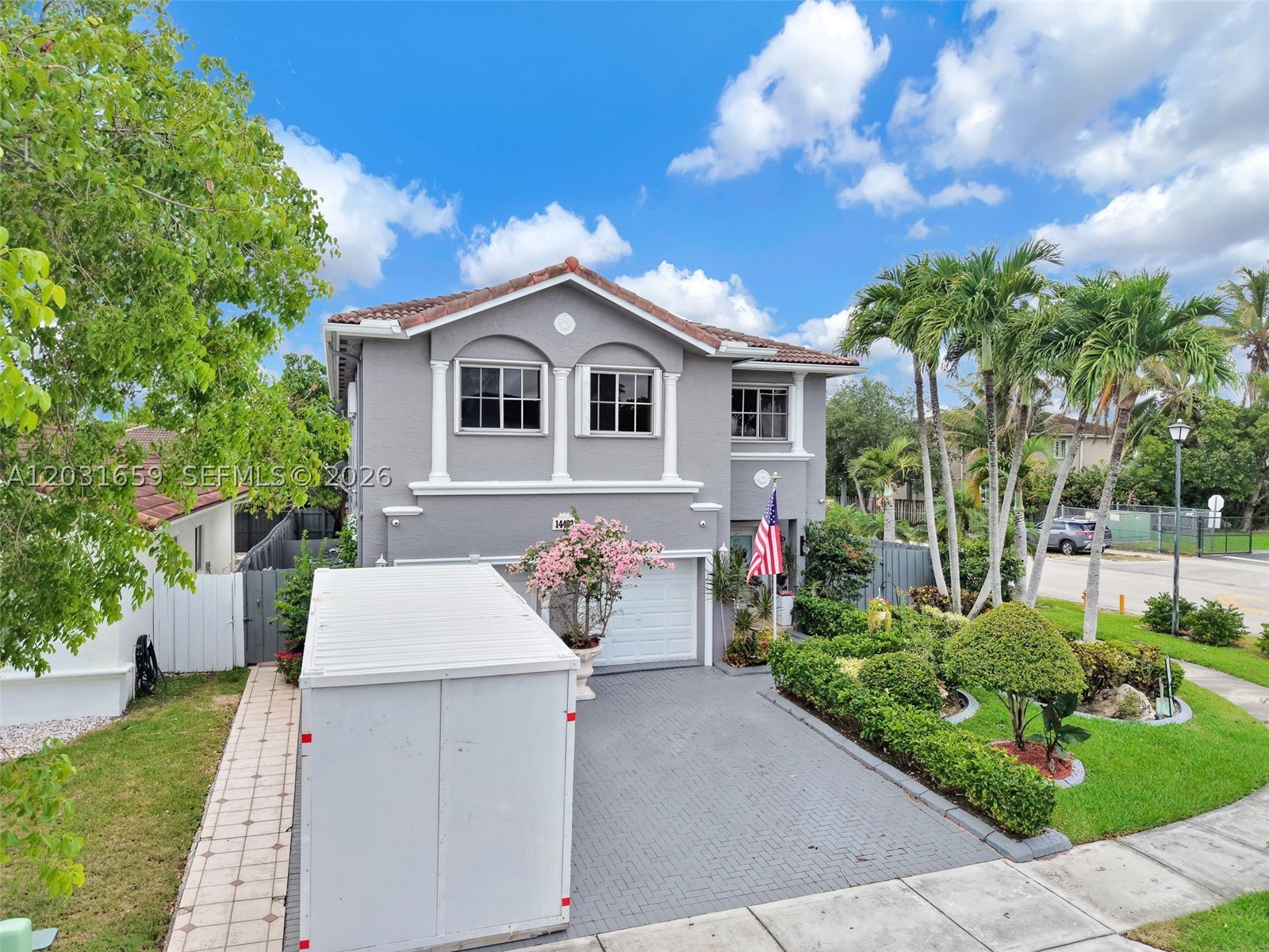 Motivated sellers! Beautifully updated 5BR/3.5BA two-story home in a sought-after neighborhood with lush landscaping and modern upgrades throughout. Features include vaulted ceilings, crown molding, custom closets, and a remodeled kitchen with waterfall quartz countertops, large island, farmhouse sink, smart appliances, wine cooler, ice maker, and THREE pantries. Flexible layout includes downstairs guest room and upstairs primary suite with three closets, soaking tub, large shower, and bidet. Secondary upstairs suite has private bath. Tropical backyard offers mature fruit trees, sprinkler system, and entertaining space. Includes hurricane shutters, ADT/fire system, cameras, and abundant storage. Walk to A+ schools, shopping, and dining.
