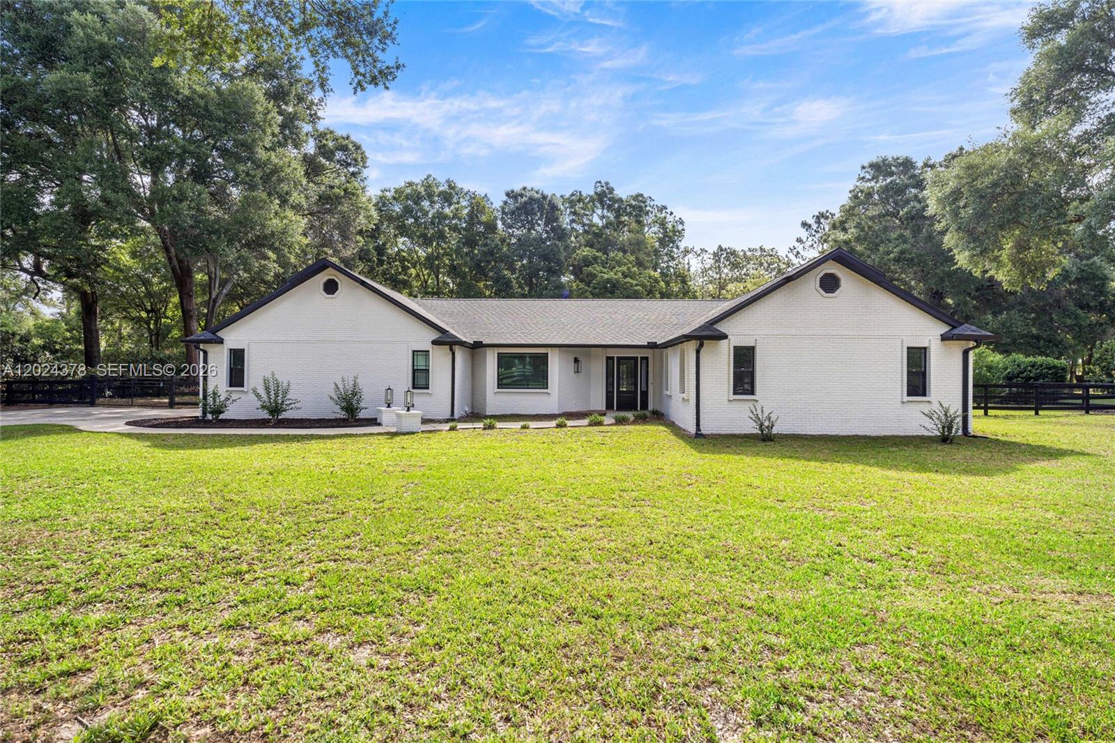 One or more photo(s) has been virtually staged. Welcome to Timberwood! One of Ocala’s most sought-after communities where you can have convenience of location and plenty of space with only a 4.5 mile drive to the world renowned World Equestrian Center. This stunning 4-bedroom, 2-bath home sits on 1.13 AC and has been completely remodeled top to bottom showcasing a bright and modern open-concept design with elegant finishes throughout. The spacious living area features beautiful wood-look tile flooring, recessed lighting, and impressive tray-style ceiling details with decorative beams that add character. The gourmet kitchen offers a large island, sleek light cabinetry, stylish pendant lighting, built-in stainless steel appliances, and plenty of counter space perfect for entertaining or everyday living. The generously sized bedrooms provide comfort and flexibility for family, guests, or a home office, while both bathrooms have been tastefully updated with modern fixtures and designer touches. Large glass doors and oversized windows bring in abundant natural light while providing serene views of the backyard and pool area. The outdoor space is just as impressive, featuring a lanai overlooking a sparkling in-ground pool surrounded by mature trees for added privacy and tranquility. Backyard includes a storage shed and plenty of room to relax, entertain, or enjoy nature.