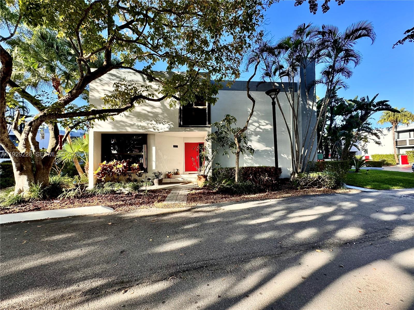 Courtyards of Aventura is a 43-unit town home development located on Williams Island Boulevard across from Maule Lake and Veterans Park, a beautiful waterfront street offering easy access in, out, and around the City of Aventura. This pet- and family-friendly community is within walking distance of shopping, dining, groceries, and a short ride to Aventura Mall and the beaches. This property features a loft-style floorplan, 1 of 6 available at the development that benefit by not sharing any major walls with other units, making it feel like living in a single-family home. The property has received many important upgrades, including impact sliding glass doors on the ground level and accordion shutters for the entire home. This floorplan offers 25’ foot high ceilings, floor to ceiling glass, a working fireplace, 2 large bedrooms on the 2nd floor with private ensuite bathrooms. Also included is a third guest powder room on the ground level, spacious walk-in closets, custom wood shelving, a large storage room, granite counters and backsplash, modern lighting and window treatments, SS open kitchen with solid wood cabinetry, extra capacity washer and dryer, 2 large porches, one off the kitchen, making it perfect for grilling. The property also includes 2 assigned parking spaces alongside the residence, making deliveries, loading, and unloading very simple. A true favorite among young families and dog owners, the Courtyards of Aventura is a lovely place to call home and a great value.