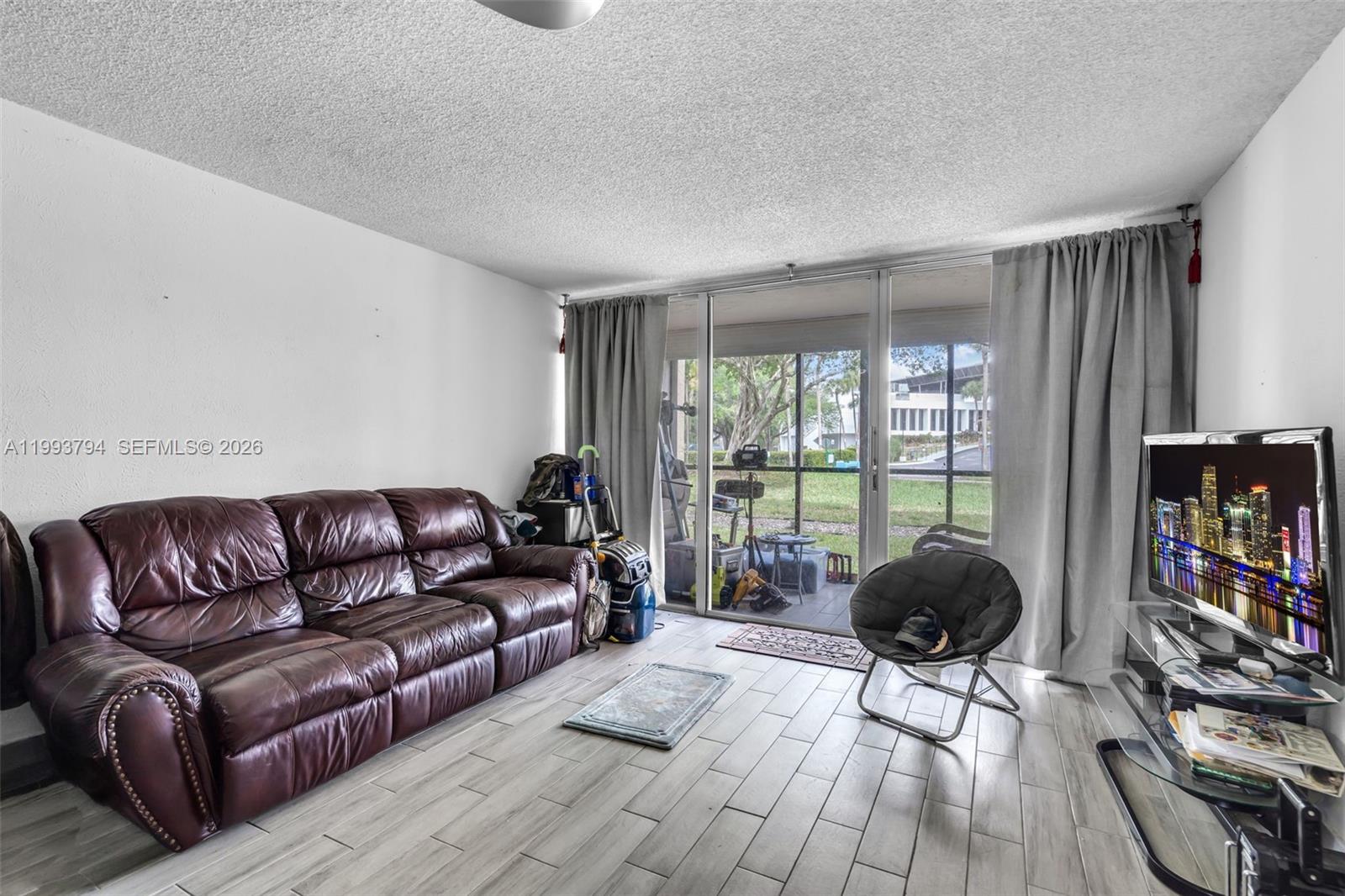 Spacious and well-maintained 2-bedroom, 2-bath first-floor condo located in the desirable Environ community. This bright and inviting unit features a functional layout with generously sized living and dining areas, perfect for both everyday living and entertaining. The kitchen offers ample cabinet space and flows seamlessly into the main living area. Enjoy the convenience of ground-floor access along with a private screened patio, ideal for relaxing while overlooking serene garden views. The primary suite includes a large walk-in closet and an en-suite bathroom for added comfort and privacy. Residents enjoy a variety of amenities, including a clubhouse, pool, fitness center, tennis courts, and more. Conveniently located near shopping, dining, major highways, and just a short drive to the beach. Ideal for homeowners or investors alike—don’t miss this great opportunity! . This unit offers great potential for personalization and upgrades to match your style. Whether you're looking for a full-time residence, seasonal getaway, or investment property, this condo provides flexibility and value. The community is well-maintained with beautifully landscaped grounds and a peaceful atmosphere. Assigned parking and guest parking are available for added convenience. Easy access to public transportation and nearby attractions makes this location highly desirable. Enjoy comfortable South Florida living at an affordable price in a community that offers both convenience and lifestyle.