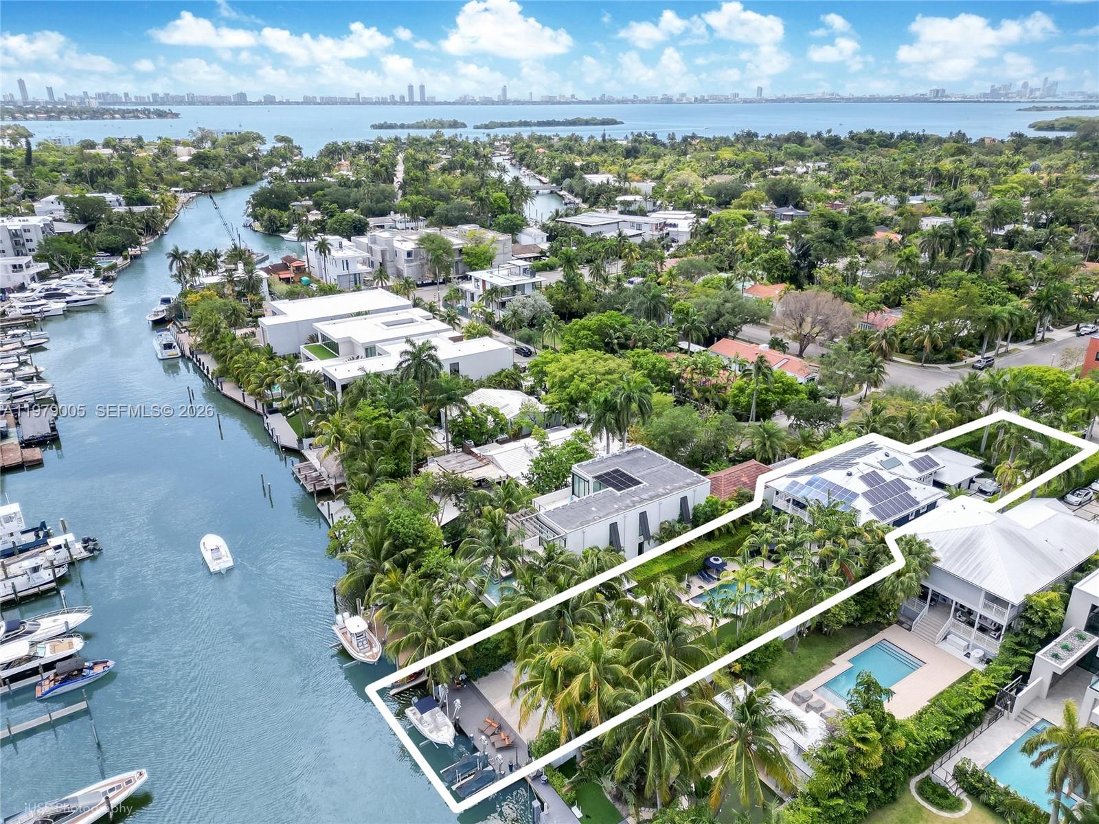 Renovated, elevated, and gated waterfront estate in guard-patrolled Belle Meade with direct bay access and no bridges. Set on a 17,350 SF lot, this 4-bedroom, 4-bath residence offers approximately 6,093 SF of total living space designed for both comfort and entertaining.

A dramatic 7.5-foot pivot entry door opens to a striking 21-foot foyer and expansive interiors with 11-foot ceilings and refined modern finishes throughout. The custom Wolf and Sub-Zero kitchen features sleek cabinetry, premium appliances, and a spacious walk-in pantry, flowing seamlessly into living and entertaining areas with a stylish indoor-outdoor wet bar. Backlit marble accents add a distinctive design element.

Outdoor spaces are designed for year-round enjoyment, highlighted by a heated 40' x 15' saltwater pool, gazebo with summer kitchen, and cabana bath. The waterfront setting includes an elevated seawall and private dock equipped with a boat lift and dual Jet Ski lifts, providing convenient access to Biscayne Bay.

Additional features include a 10-car motor court, impact glass, Lutron lighting system, whole-house generator, two new 5-ton AC units, and 77 solar panels for enhanced energy efficiency. A full smart security system completes this thoughtfully upgraded waterfront residence.