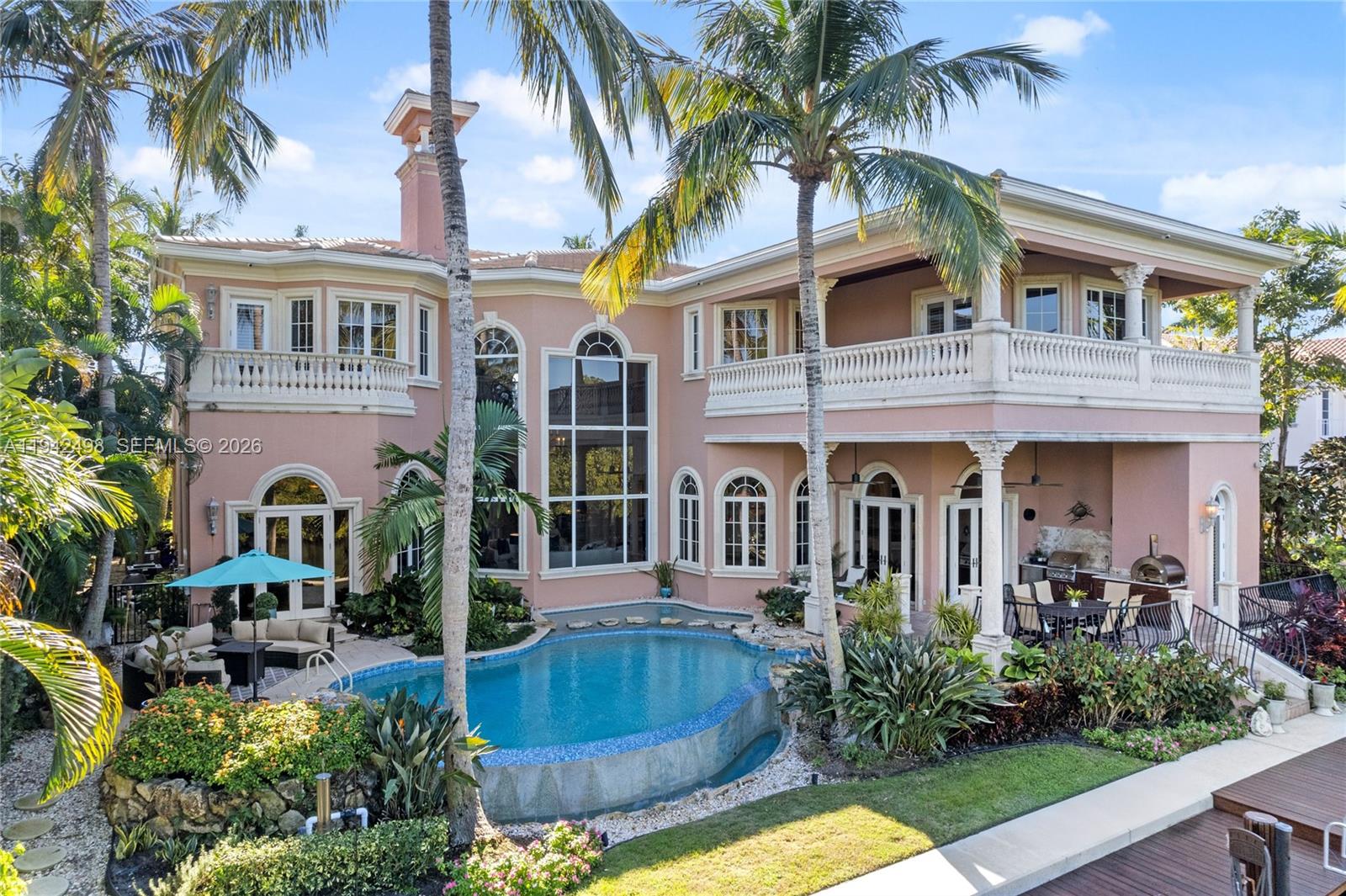 BRAND NEW ROOF! Waterfront estate built by renowned Turtle Beach construction of the Palm Beaches. Located in the prestigious Harbour Isles of North Palm Beach. Grand entrance with soaring floor-to-ceiling windows looking out across the sparkling infinity edge pool and spa. This house is a boat owners dream with 90 feet of dock. The home's custom finishes, marble floors, and detailed trim & moldings set an elegant tone throughout, while the home's countless custom features make entertaining effortless: home theater room, impressive chef's kitchen, outdoor kitchen, living room gas fireplace with full bar adjacent. The house has a commercial grade elevator, wood paneled office with fireplace, upstairs & downstairs laundry rooms.