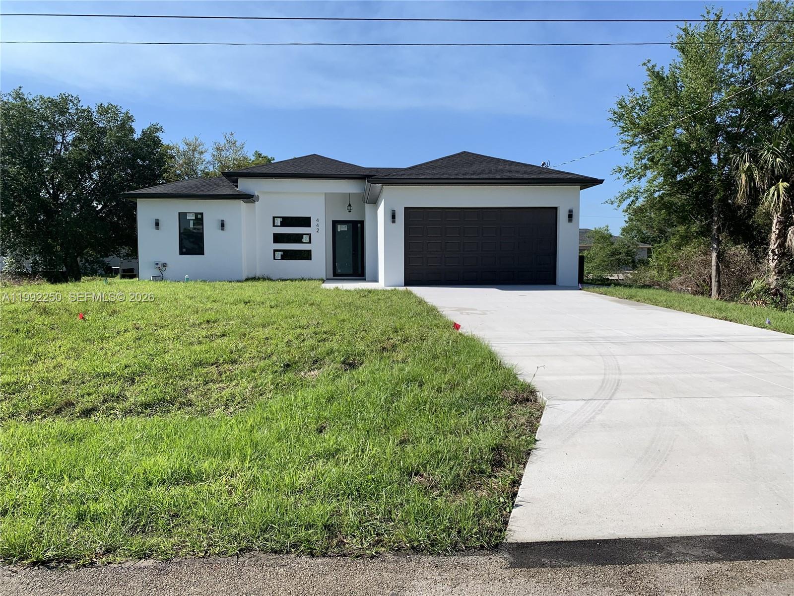 Don’t miss this brand-new construction home located just minutes from Fort Myers in the growing Lehigh Acres community. This beautifully designed residence features 3 spacious bedrooms, 2 full baths, and an open-concept layout filled with natural light.  Enjoy a large modern kitchen complete with stainless steel appliances, quartz countertops, and ample cabinetry—perfect for both daily living and entertaining. Additional highlights include a two-car garage, a lanai with a half Bath, and quality finishes throughout.  Whether you're a first-time homebuyer, a growing family, or an investor, this move-in-ready home offers comfort, style, and convenience in one of Southwest Florida’s fastest-growing areas.