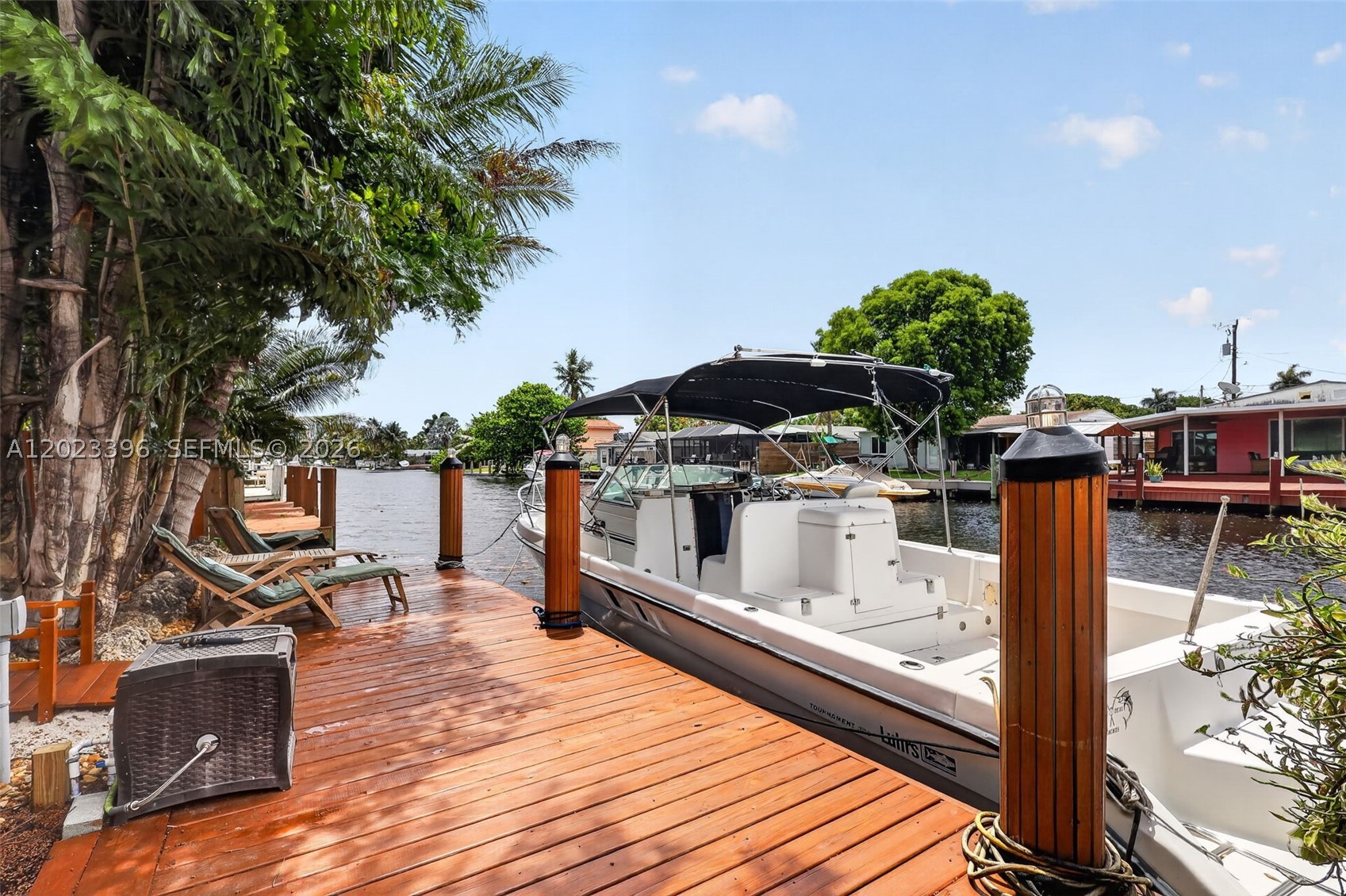 Appraised at $760K! Waterfront living in the heart of Hollywood! This beautifully positioned home offers the perfect blend of convenience, coastal charm, & relaxed waterfront living. Featuring ocean access from your own private dock & ideal for boaters & anyone seeking the true South Florida lifestyle. Designed for both entertaining & everyday enjoyment, the backyard is a private oasis featuring a heated spa pool & spacious tiki hut w/bar, a tranquil pond w/fountain & hammock retreat add to the serene atmosphere, creating the perfect place to unwind & enjoy the coastal breeze. Conveniently located near the famous Yellow Green Farmers Market, the home is also located just minutes from Ft. Lauderdale airport, cruise terminals, & pristine beaches. Enjoy fishing/kayaking/boating directly from your private backyard while surrounded by abundant marine life, native exotic birds, & seasonal visits from gentle Florida manatees. Inside, the residence features a warm coastal aesthetic w/spacious open living areas, abundant natural light, & seamless indoor-outdoor flow. The kitchen offers custom wood cabinetry w/direct views of the outdoor entertaining areas. Additional upgrades include metal roof and impact windows/doors, providing peace of mind & enhancing the home’s bright, airy feel. This home offers unmatched access to dining, shopping, entertainment, beaches, boating, & travel. The best of waterfront living w/everyday convenience at your doorstep. Property Sq ft is 1620.