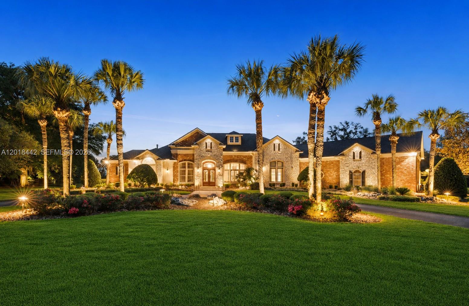 Luxury estate on over 5 private acres in the gated community of The Grove, offering 5 bedrooms, 5.5 bathrooms, and over 5,100 heated square feet. This home features soaring ceilings, travertine flooring, multiple fireplaces, a gourmet kitchen with dual Sub-Zero refrigerators, Control4 smart home automation, a built-in bar, resort-style pool, outdoor fireplace, surround sound, and beautifully landscaped grounds.