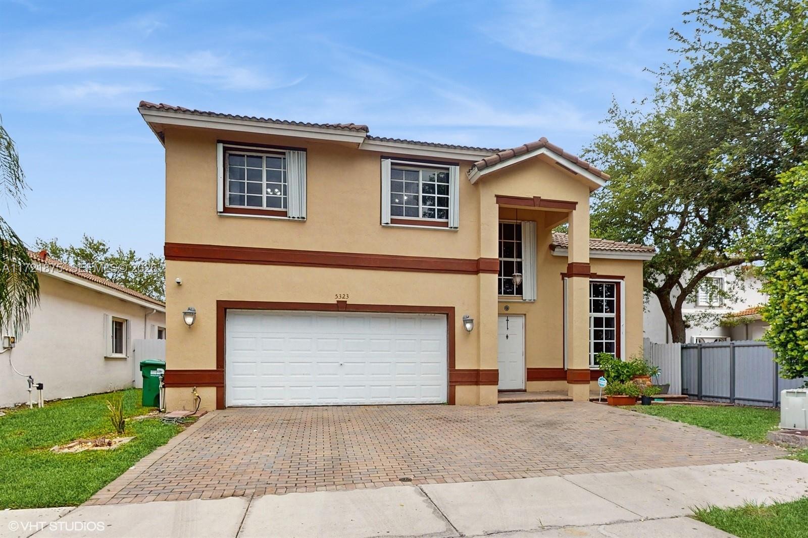 The Happy Home-Located on a quiet cul-de-sac within Doral Gardens,a gated community. Spacious 2 Story home HOA (Only $315.00 Monthly), Built 2000.  4 Bedrooms 3 full baths. Atractive "split floorplan" for multi-generational lifestyle. (Upstairs-3 bedrooms 2 baths  Downstairs- One bedroom 1 full bath.) 2 car garage, Updated kitchen, counter seating. Food & butlers pantry. Laundry room, Lots of storage space throughout. Natural light and high ceilings fill this home with great energy. Full storm protection. Great floorplan and location. Well maintained, home is ready for you to enjoy it is (TURNKEY & MOVE-IN READY!) Private back yard  with covered terrace enjoy as-is or build a pool ! Ample parking for family and friends.