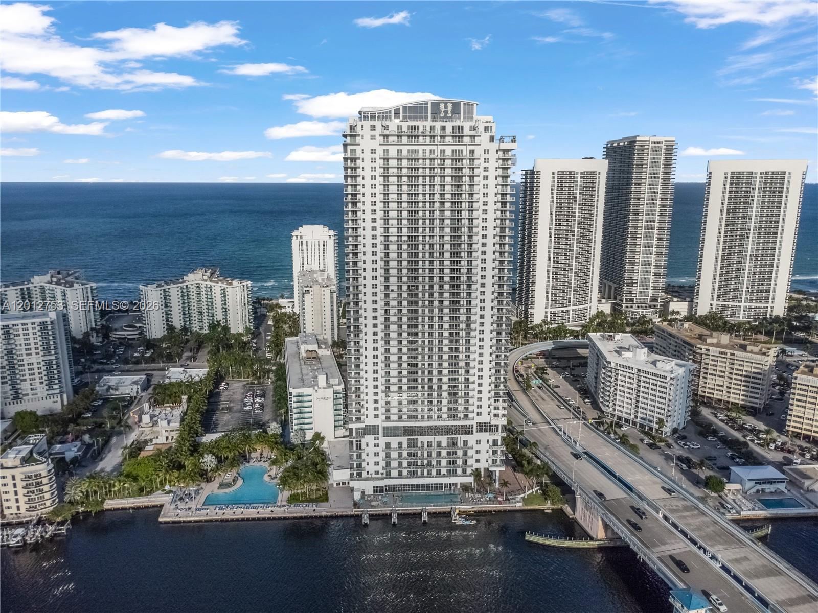 Beach-inspired, high-rise turnkey residence offering a new condo-hotel concept. This fully furnished 2-bedroom, 2-bath unit features 1,225 sq ft of interior space and a spacious terrace with breathtaking views of the ocean and Intracoastal, totaling 1,689 sq ft.
Designed with upscale finishes, the residence includes an oversized walk-in closet and is move-in ready. Smart building technology offers fiber optics for high-speed internet, cable TV, and individual climate control systems.
Resort-style amenities include an infinity-edge pool, semi-private cabanas, outdoor kitchen and dining areas, and a full Sports Club with outdoor tennis, indoor racquetball and basketball courts, plus a state-of-the-art fitness center overlooking the pool deck and Intracoastal.
Ideal for investors—flexible rental options allow for self-management, participation in the hotel program, or use of a third-party management company.