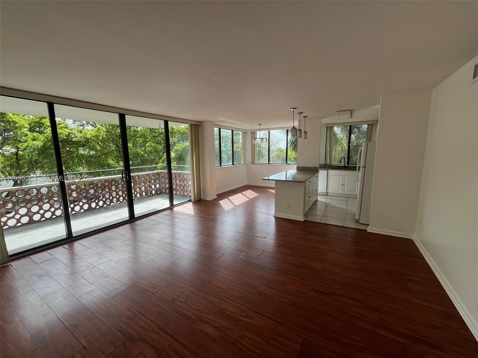 Move right into this spacious, updated 2-bedroom, 2-bathroom apartment. Located in a peaceful, family-friendly area, it features a large master bedroom with a beautiful shower and walk-in closet. The open layout includes a modern kitchen and dining area. Wood floors throughout, tiled bathrooms, windows in every room and a large balcony. Well maintained property lobby and grounds. Minutes from local shops and restaurants.