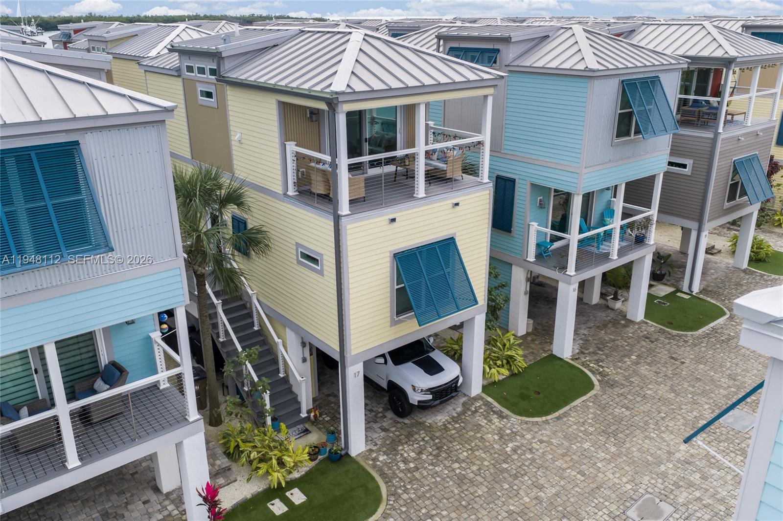 The Keys are calling! Welcome to this beautifully appointed 2-bedroom, 2-bath residence offering the island lifestyle you’ve been dreaming of—without the steep price tag. This light-filled home features a stylish granite and stainless-steel kitchen, central air conditioning, and convenient interior laundry, making everyday living both comfortable and effortless.

Step outside to the third-floor balcony, where open water and ocean views create the perfect backdrop for morning coffee or evening sunsets.

Located within a true oceanfront community, residents enjoy an impressive array of amenities, including a resort-style pool, covered parking, kayak launch area, and a waterfront community lounge complete with a sun deck, fire pits, and an outdoor kitchen with stainless-steel grill—ideal for relaxing or entertaining.

Perfectly situated in the heart of Marathon, just 2.5 hours from Miami and approximately one hour from Key West, this property delivers the best of the Florida Keys lifestyle with convenience and accessibility.

With no HOA fees, property taxes included, and a full-time property management company maintaining the common areas, ownership here is truly low maintenance—just arrive and enjoy island living. This is the most affordable new-construction opportunity in the Keys, offering unmatched amenities for the price.

Please note: the property is subject to monthly lot rent