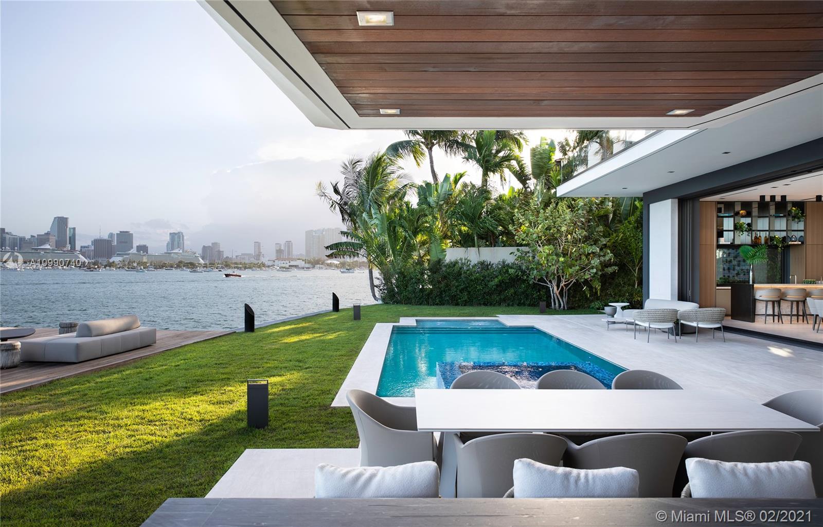 New waterfront mansion sited on the premier southern lot on Venetian Islands embodies the ideal combination of modern architectural simplicity, unobstructed Miami skyline views, & luxe amenities put together in an indulgent fashion. Dramatic entry with double-height ceilings leads to living areas with 12-ft ceilings, Boffi kitchen+chef's kitchen, family rm, dining area, entertainment bar, & living rm with auto doors. Top-of-the-line finishes, theater with state-of-the-art sound, Savant home-automation, Boffi fixtures, Porsche Design lighting. This masterful creation was brought to life with collaboration of multiple outstanding minds. Built by Ramin Designs, designed by Dunagan Diverio Design Group, staged by Artefacto, art curated by Fredric Snitzer Gallery.