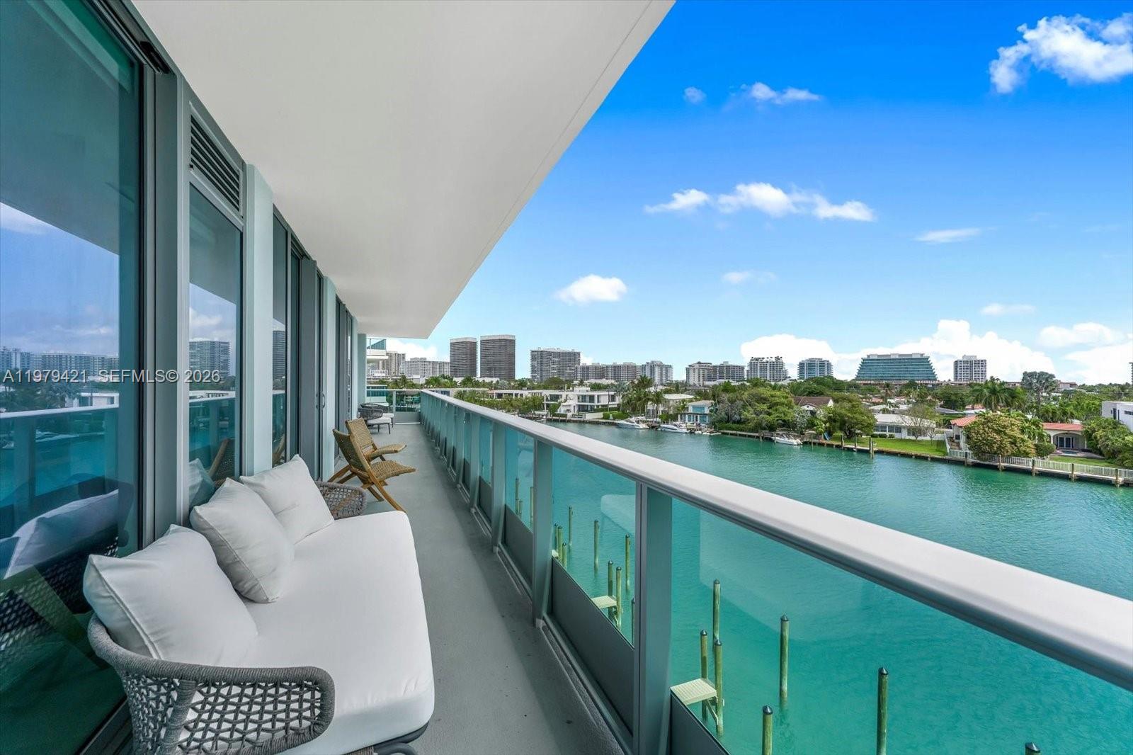 Offered fully furnished with built out closets and blinds, this turnkey residence delivers immediate gratification without the wait of new construction and at a compelling value, priced approximately $250K–$400K below comparable inventory. Located in the boutique waterfront building La Baia South, this brand new residence showcases exceptional views of the canal, Bal Harbour Islands, and the ocean. The home offers 3 bedrooms, 3.5 bathrooms, and two parking spaces. Features include wood flooring throughout and a sleek modern kitchen with Miele appliances, quartz countertops, and custom cabinetry. A separate laundry room includes a Miele washer and dryer. The primary suite features two walk-in closets and a spa-inspired bathroom with marble finishes, Snaidero cabinetry, and a walk-in shower. Residents enjoy concierge service, 24-hour valet, rooftop pool with sundeck, lounge areas, fitness center, and dedicated yoga spaces. Ideally located near fine dining, the beach, houses of worship, schools, and Bal Harbour Shops.