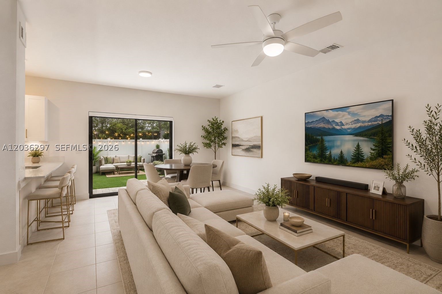 Built in 2022 and move-in ready, this townhome in the highly desirable Vista Lago community offers the rare combination of modern construction, thoughtful design, and everyday practicality that is increasingly hard to find in today's market. The open main level features porcelain tile flooring, ceiling lighting, and a kitchen finished with quartz countertops, modern white cabinetry, stainless appliances, ample storage, and a generous breakfast bar, ideal for daily life and gatherings. Step outside and the living space continues, with a fully fenced backyard featuring premium synthetic turf, a clean and low-maintenance outdoor space perfect for entertaining, children, or pets. Upstairs, the primary suite offers a walk-in closet and an ensuite bath with dual vanities, quartz surfaces, and a frameless glass shower. Upstairs laundry and generous storage throughout add everyday convenience. Parking for four with an attached garage and three spaces in front. Impact-resistant windows, doors, and hurricane shutters provide peace of mind year-round. Vista Lago's Mediterranean-inspired community features a resort-style pool, clubhouse, fitness center, and playground set among manicured grounds. Conveniently positioned near I-95, Florida's Turnpike, SR-441, Aventura, Hard Rock Stadium, shopping, dining, parks, schools, houses of worship, and everyday conveniences, everything you need is within easy reach. VIRTUALLY STAGED PHOTOS INCLUDED.