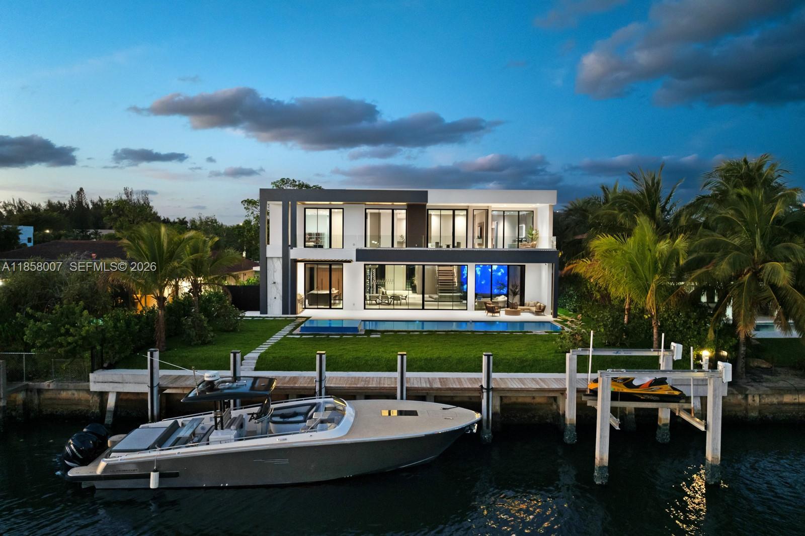Crafted by Barreto Constructions, this 2024 new-construction waterfront estate presents a rare opportunity within the gated enclave of Golden Isles. Offering 9,536 total sq. ft., 85 feet of canal frontage, and direct ocean access with no fixed bridges, the residence combines architectural presence with immediate lifestyle execution.
Designed with 11-ft ceilings and expansive open living spaces, this 6BD/6BA/2HB modern home features 2 primary bedrooms,  a Mia Cucina Italian marble kitchen, integrated smart home and smart glass systems, premium sound, dual coffee stations, and a 160+ bottle temperature-controlled wine cellar.
Outdoor living is elevated with a resort-style pool and spa, covered terrace, summer kitchen with draft beer system, and upper-level wet bar. A newly constructed seawall built to current regulations and private dock enhance long-term waterfront integrity.
Additional highlights include a rare 979 SF climate-controlled collector’s garage within a 4-car configuration, spacious drive way for 6+ cars, Laundry Jet system, steam/dry-cleaning station, and 1,494 SF of finished terraces and balconies.
Fully completed and move-in ready, this 2024 new-construction waterfront situated in Golden Isles, gated community with parks, dog park, multiple tennis courts, it is minutes from beaches, golf, casino, and Aventura Mall.