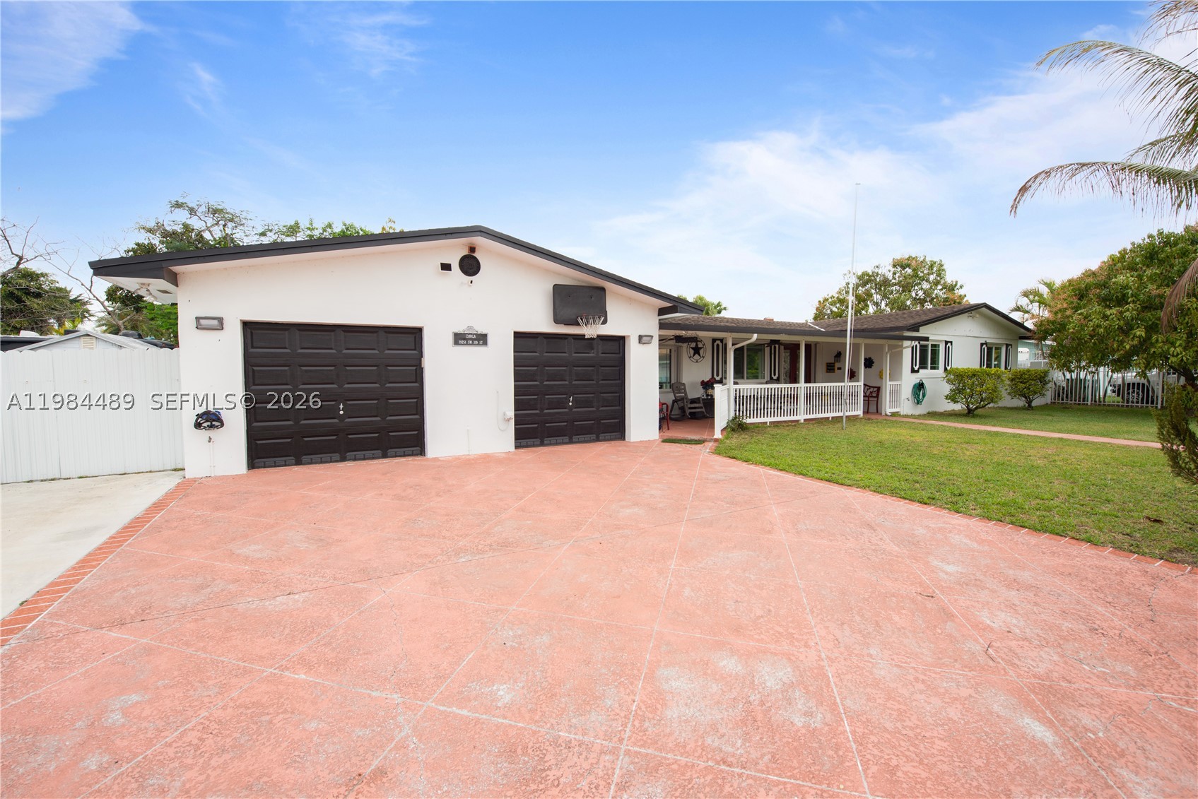 ** PRICE IMPROVEMENT ** Charming 3/2 home in Mowry Drive Estates offering spacious indoor and outdoor living. Inviting living room with tile floors, fan/light, drapes, and double doors for great natural light. Comfortable family room features built-in shelves, tile flooring, and fan/light—perfect for relaxing or entertaining. Kitchen includes black & white tile countertops, stainless steel refrigerator and stove, plus a convenient snack bar. Dining area with chandelier adds a warm touch for gatherings. Primary suite features tile flooring, fan/light, walk-in closet, and a private bath with one sink and walk-in shower. Secondary bedrooms offer tile floors, blinds, ceiling fans/lights, and ample closet space. Second bath also includes a walk-in shower and one sink. Spare room currently used as a movie room but could easily be converted into an office or in law quarters. Enjoy outdoor living with a covered/screened patio, outdoor kitchen, and plenty of space for entertaining. Property includes a swing set/playground, additional covered storage, and a large front patio. Fully fenced with electric gate for added privacy. Oversized 4-car garage with 3 doors and workbench provides excellent workspace and storage. PROOF OF FUNDS AND/OR PRE-APPROVAL LETTER REQUIRED PRIOR TO SCHEDULING A SHOWING OF THE PROPERTY!