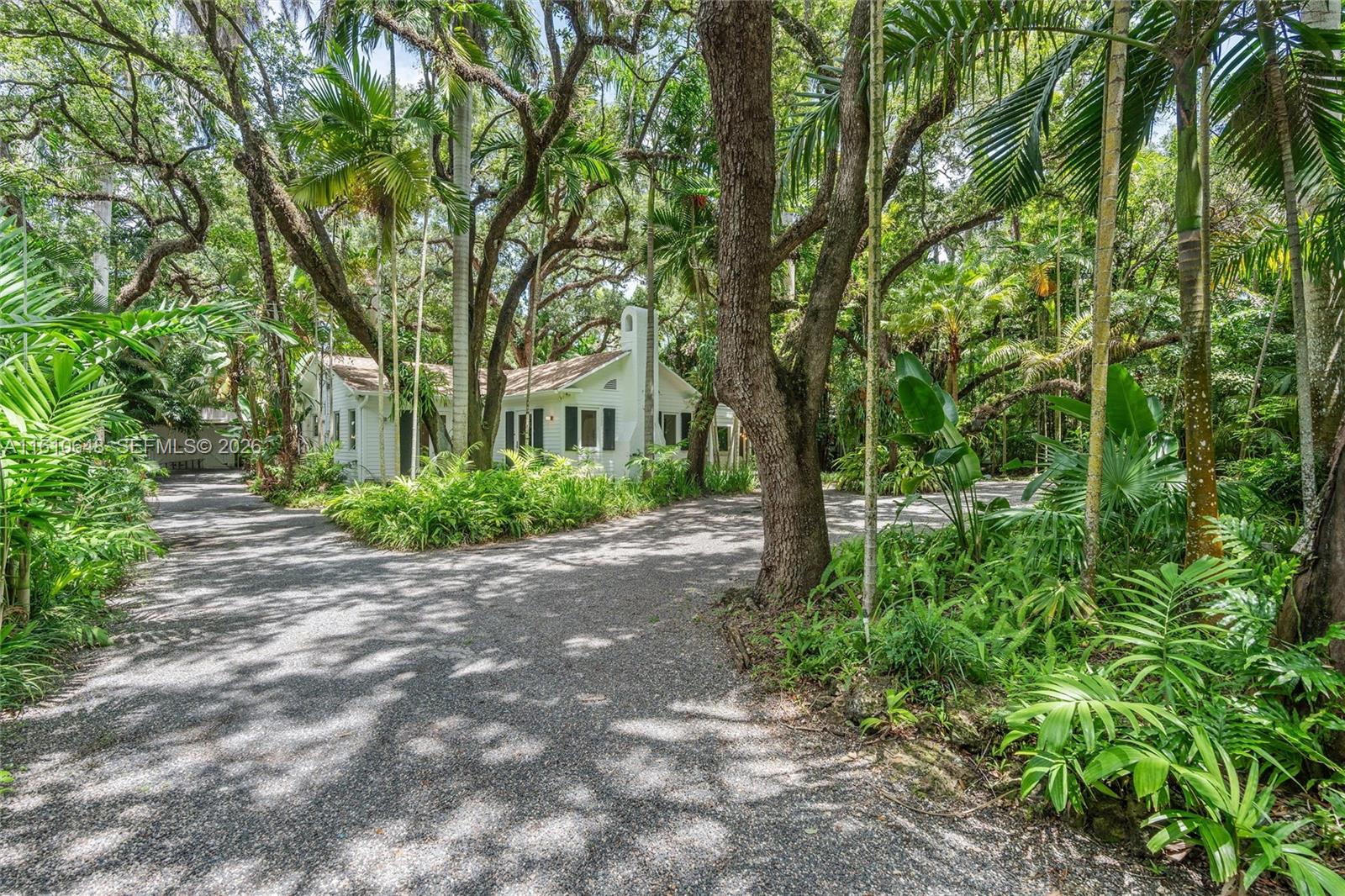 Exquisitely renovated, impeccably appointed Craftsman-inspired “Millionaire’s Row” North Grove home perched on a gorgeous, gated builder’s 1/2-acre lot. A tropical hardwood hammock frames the picture-postcard property & expansive 3/3 cottage. Timeless character (oolitic limestone, brick, wood floors, tongue/groove ceilings) complements modern, generously scaled interiors. Spacious living rm opens to a sun-filled Florida rm. Fully outfitted marble/stainless steel eat-in kitchen; adjoining dining rm. Sleek/elegant baths. En-suite primary & secondary bdrms; #3 can dbl as office. Screened wraparound porch & gracious patios = easy indoor/outdoor entertaining. New roof, impact windows & door. Make this captivating “Old Grove” estate your own or build to suit!