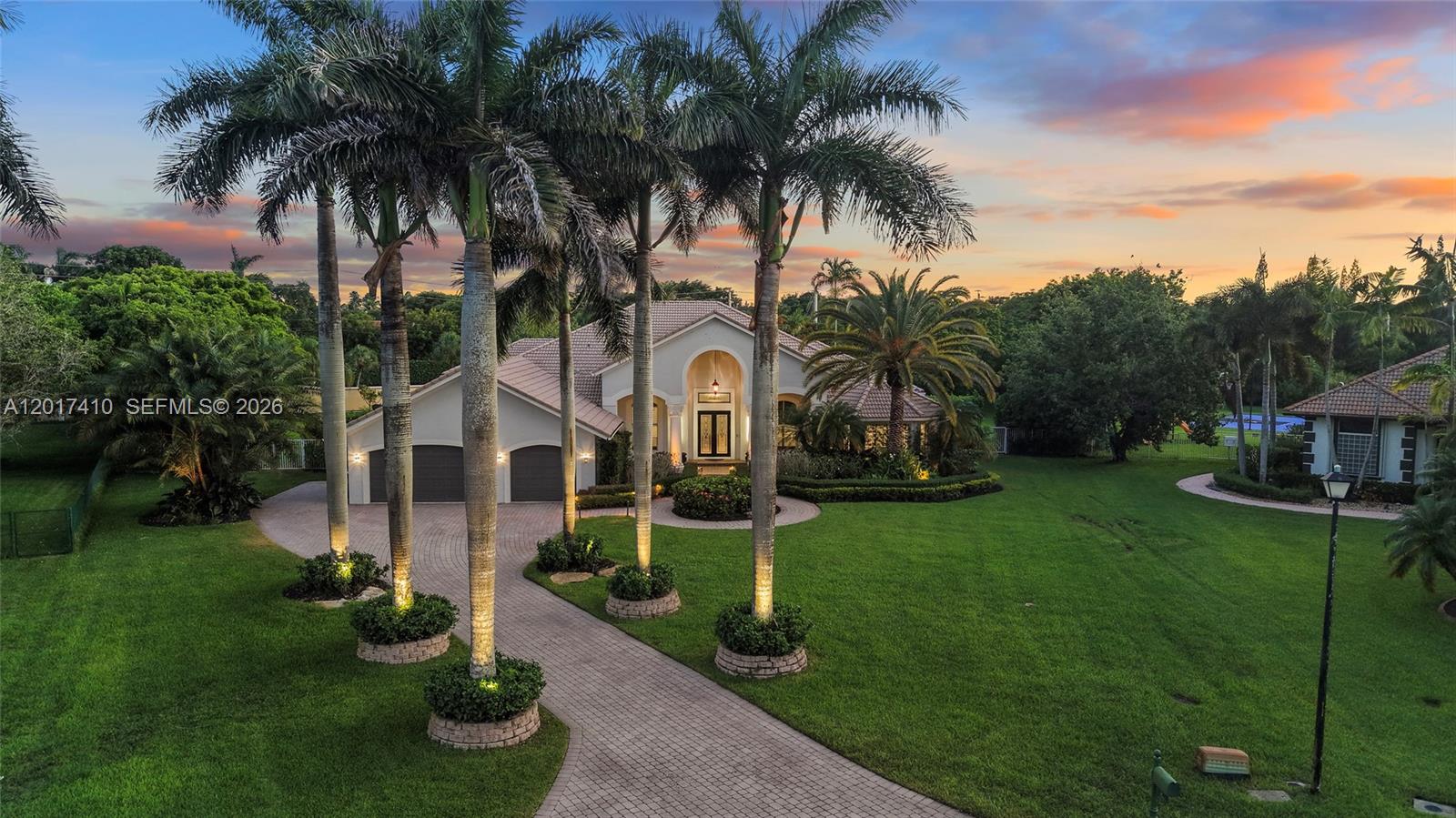 Set within the prestigious gated enclave of Emerald Springs Estates, this fully reimagined modern residence sits on the community's largest lot, an exceptional 1.5 acres of professionally designed grounds offering rare scale, privacy, and resort-style living in South Florida. Renovated in 2021 with no detail overlooked, all four bedrooms and four bathrooms were redesigned with new showers, designer fixtures, custom closets, and sleek white porcelain flooring throughout. The primary suite is a true retreat featuring an oversized bedroom and a Chanel-inspired walk-in closet with luxury designer flooring. The fully reimagined kitchen showcases top-tier finishes and an impressive Fulgor Milano appliance package including two refrigerators, wine fridge, double oven, drawer microwave, built-in espresso machine, island beverage fridge, and Bosch dishwasher. The pool and spa were renovated in 2021 creating a resort-style setting complete with a private sports court. Additional upgrades include three A/C units, new water heater, washer and dryer, and accordion shutters. With 1.5 acres of usable land there is still room to add an outdoor kitchen, guest quarters, or additional luxury amenities. A rare Davie estate where the lot, renovation, privacy, and location all come together at the highest level.