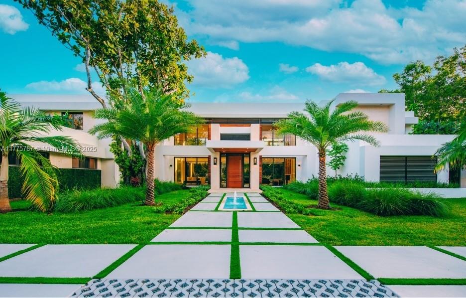 RELISTED TO SELL - Nestled on a tranquil road in desirable North Pinecrest, this stunning modern residence sits on a sprawling .88 acre lot. With 22' high ceilings, the spacious 2-story floor plan is flooded with natural light, creating a bright and airy ambiance. Additional features are: living room, 2 family rooms, a formal dining room, an office-gym, a 4-person elevator, and a home theater, this residence is the epitome of luxury living. The exterior includes expansive covered terraces, complete with an outdoor BBQ, perfect for entertaining guests. With ample parking available, you can host family and friends with ease. This exceptional property is READY NOW