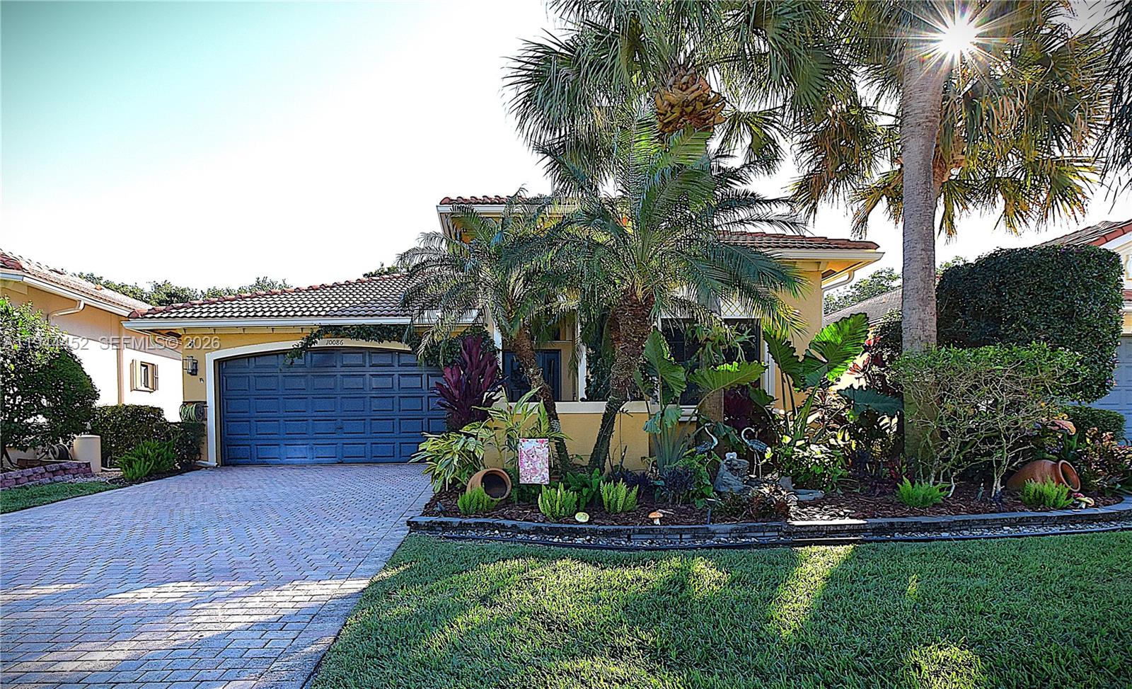 This beautifully updated 3-bedroom home in Tivoli Lakes greets you with a spacious open floor plan, a charming foyer, and lush landscaping surrounding the front, sides, and back. The counter-height, eat-in kitchen includes a built-in desk, while 11-foot ceilings with crown molding run throughout the home, complemented by a stunning tray ceiling in the master bedroom. The kitchen and second bathroom have been stylishly renovated, and the electric fireplace features stonework extending to the ceiling. Fixtures, window treatments, and chandeliers have all been thoughtfully updated. The garage offers an epoxied floor and added stylish cabinets for organized storage. The master bath boasts two fully built-out walk-in closets. Out back, enjoy a screened-in patio surrounded by tropical greenery. Tivoli Lakes is fully fenced with a 24-hour manned security gate and offers amenities including a theater, grand ballroom, fully equipped gym, pickleball and clay tennis courts, billiards and card rooms, a heated pool, jacuzzi, shuffleboard, and more. Conveniently close to beaches, the Turnpike, and I-95.
Flooring updated in 2021 along with new baseboards and crown molding. Kitchen full remodel 2023 with Quartzite countertops. Storage in built ins, MB Closets, Office reading nook, garage cabinets and epoxy flooring done in 2021. Custom window treatments and blinds done 2023.

Please be sure to click on 360Degree link for a virtual tour of the home online.