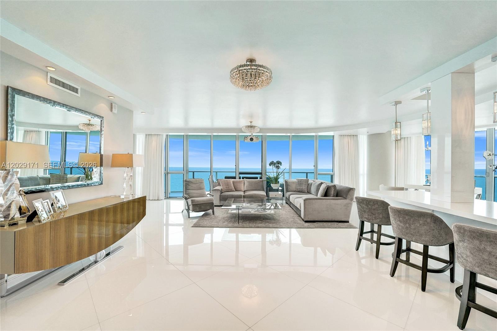 Experience elevated oceanfront living in this fully customized east-facing residence at Ocean Palms, offering over 3,000 SF of luxurious living space and breathtaking direct Atlantic Ocean views. Designed for both comfort and entertaining, the home features a drop-down projection screen, touchscreen entertainment system, bespoke Downsview cabinetry, premium Miele appliances, crystal light fixtures and designer furnishings by Bernhardt, HSTUDIO and Nathan Anthony. The spacious floor plan is complemented by oversized terraces, spa-inspired baths, custom finishes throughout and an Electrolux washer and dryer. Residents enjoy world-class amenities including direct beach access, oceanfront pool deck, fitness center and spa, tennis court, media room, concierge, valet parking and 24-hour security. A rare opportunity to own an exceptional turnkey oceanfront residence in one of Hollywood Beach’s premier luxury towers.
