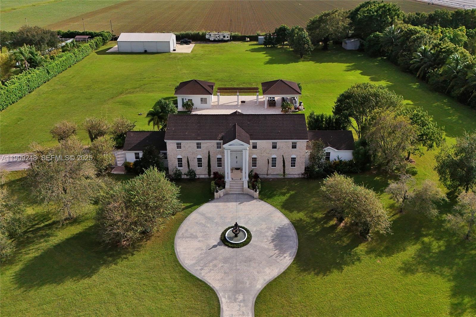 Welcome to Lindbergh’s Landing where elegance and luxury meet on 6.25 acres in one of South Florida’s most exclusive private enclaves. This architectural masterpiece features 23-ft ceilings, marble finishes, and expansive open living spaces that exude modern sophistication. The 4BR/3.5BA main home offers a large open floor plan with upstairs den, Additionally separate 2BR/1BA guest residence with full kitchen and laundry. Enjoy your own private resort with tropical landscaping, manicured grounds, and a 1BR/1BA cabana apt with full kitchen for guests. The state-of-the-art “Ultimate Man Cave” provides endless possibilities for private jets, exotic cars, or equestrian pursuits. The community offers a 7,000-ft private runway-a lifestyle without boundaries where the sky is truly the limit.