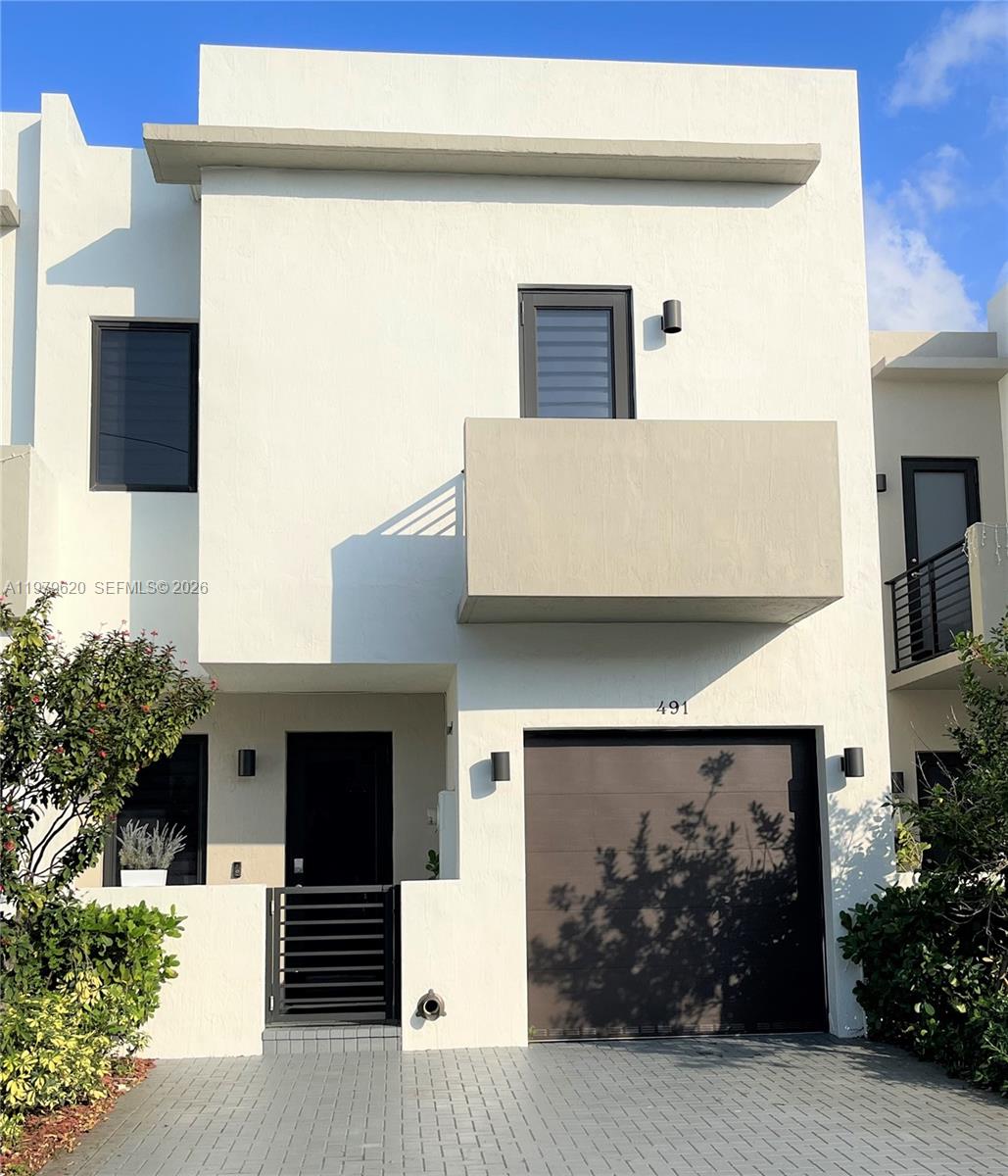 Modern, Open, Carefree living, a rare 4 bedroom 3 and a half bath, located in Century Park Place. Gain access with a keyless entry system and Ring doorbell. The many features include: The Kitchen has a generous amount of counter space, white cabinets, quarts counter tops, stainless steel appliances. The separate laundry room houses a washer and dryer. Impact window and doors. All the bedrooms are upstairs: Primary Bedroom has an en-suite bathroom with double sinks and walk-in closet. The second (Jr. Suite) has its own bathroom and balcony. The spacious fenced private patio is perfect for relaxing or entertaining. There is plenty of parking: a one car garage and space for two other cars right in the drive. This is the best value in the complex.