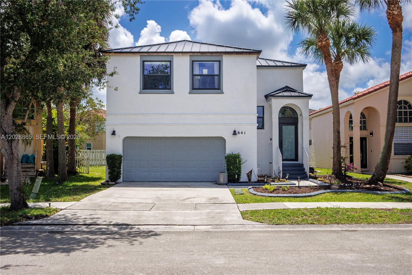 Beautifully renovated 4-BED, 2.5-BATH home in the sought-after community of Towngate, Pembroke Pines. Every detail reflects a refined sense of style. SOARING CEILINGS, OPEN-CONCEPT LAYOUT, natural oak-look laminate floors, and an ELECTRIC FIREPLACE create a warm, light-filled space. The MASSIVE KITCHEN features a giant island, MARBLE look and TRANSLUCENT DOLOMITE counters, two-tone oak and sage green cabinetry, a BUILT-IN CUSTOM RANGE HOOD, and PREMIUM CAFE and ZLINE APPLIANCES —all with brushed bronze hardware. The EXPANSIVE PRIMARY SUITE offers a custom walk-in closet and SPA BATH w. DOUBLE SINKS, OVAL SOAKING TUB & SHOWER. Three additional bedrooms and a guest bath complete the upper level. BRAND-NEW METAL ROOF, IMPACT WINDOWS & DOORS, and a two-car garage round out this move-in ready home. Community life revolves around Towngate Park, a central recreation facility with exclusive access to a large community pool, tennis and basketball courts, soccer field, and fitness center. Mahogany Way residents also enjoy a private pool & children's playground. - DISCLOSURE: GARAGE DOOR NOT IMPACT RESISTANT, Property taxes include a PACE loan that will be paid in full at closing. It represents approx. $7000/yr in taxes-. Minutes from I-75, top-rated A+ schools, shopping, dining, and perfectly positioned between Miami and Fort Lauderdale. Don't miss this exceptional home in one of Pembroke Pines' most coveted addresses! Video Tour available. SHOWINGS ON SAT 6/6, call L.Agent to schedule
